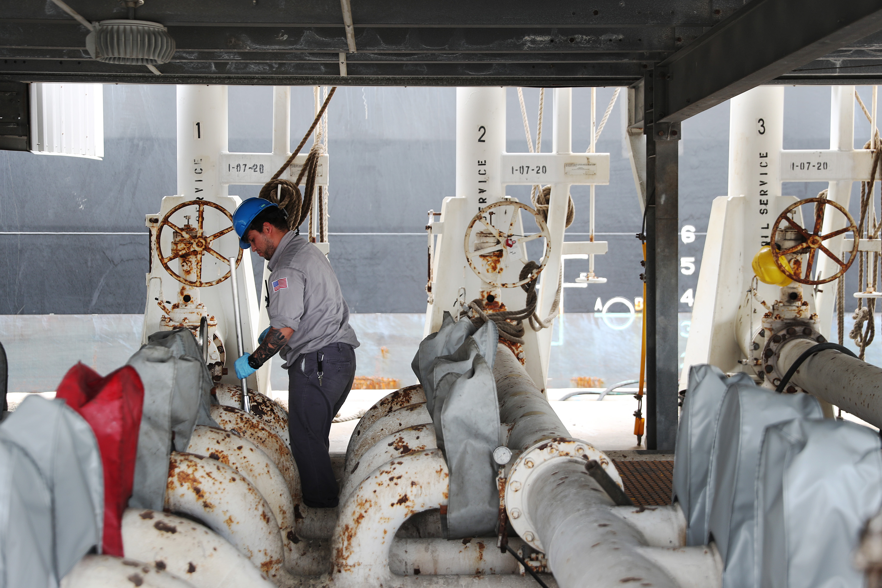 Dock workers prepare to offload oil from the tanker, Texas Voyager, as it pulls into its mooring at Port Everglades on April 21, 2020 in Fort Lauderdale, Florida. The price of West Texas Intermediate oil futures for delivery in May fell yesterday to -$37 per barrel for the first time in history. The price continues to be at record lows as demand for crude oil has decreased amid the coronavirus pandemic. (Photo by Joe Raedle/Getty Images)