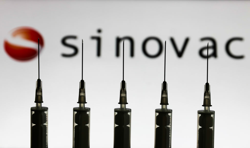Medical syringes are seen with Sinovac Biotech company logo.