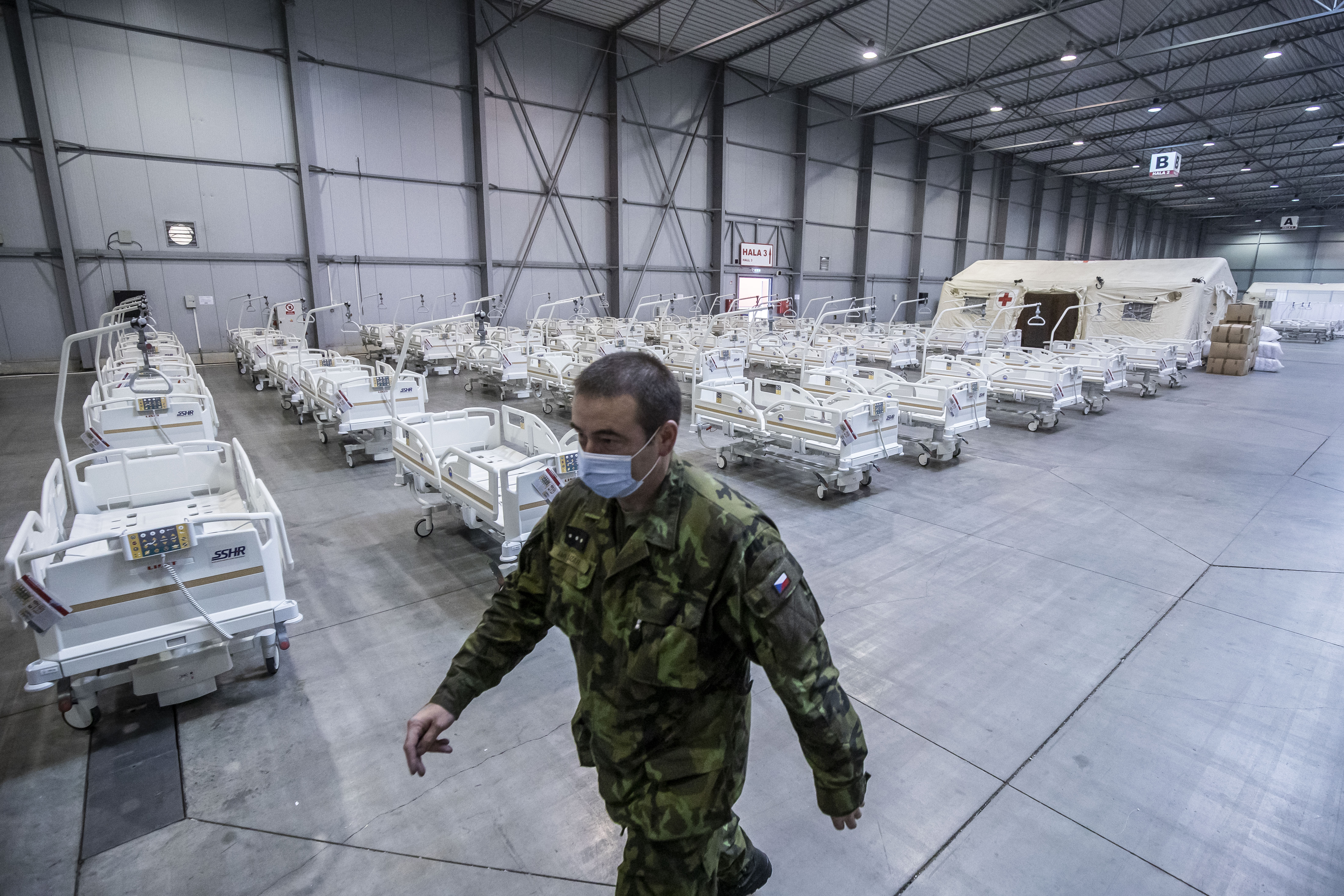 Member of the Czech Army walks past medical beds inside of field hospital built in an exhibition center for patients who suffer the coronavirus disease on October 22, 2020 in Prague, Czech Republic.