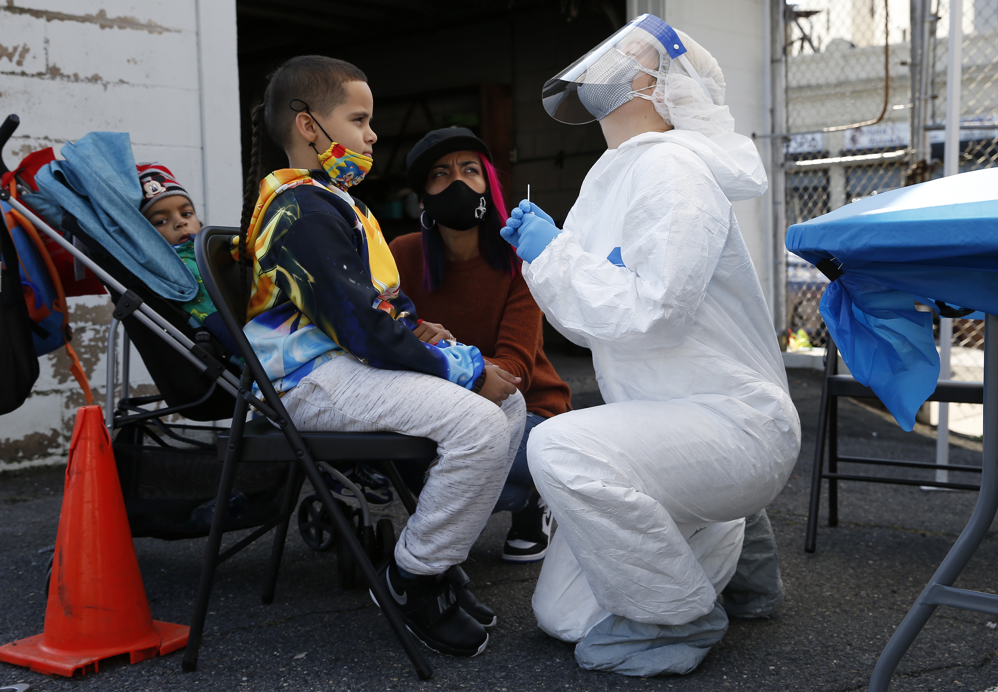 A nurse in Boston prepares to administer a COVID test. To counteract the effects of the pandemic, America needs a G.I. Bill–like initiative for essential frontline workers, writes Bill George.