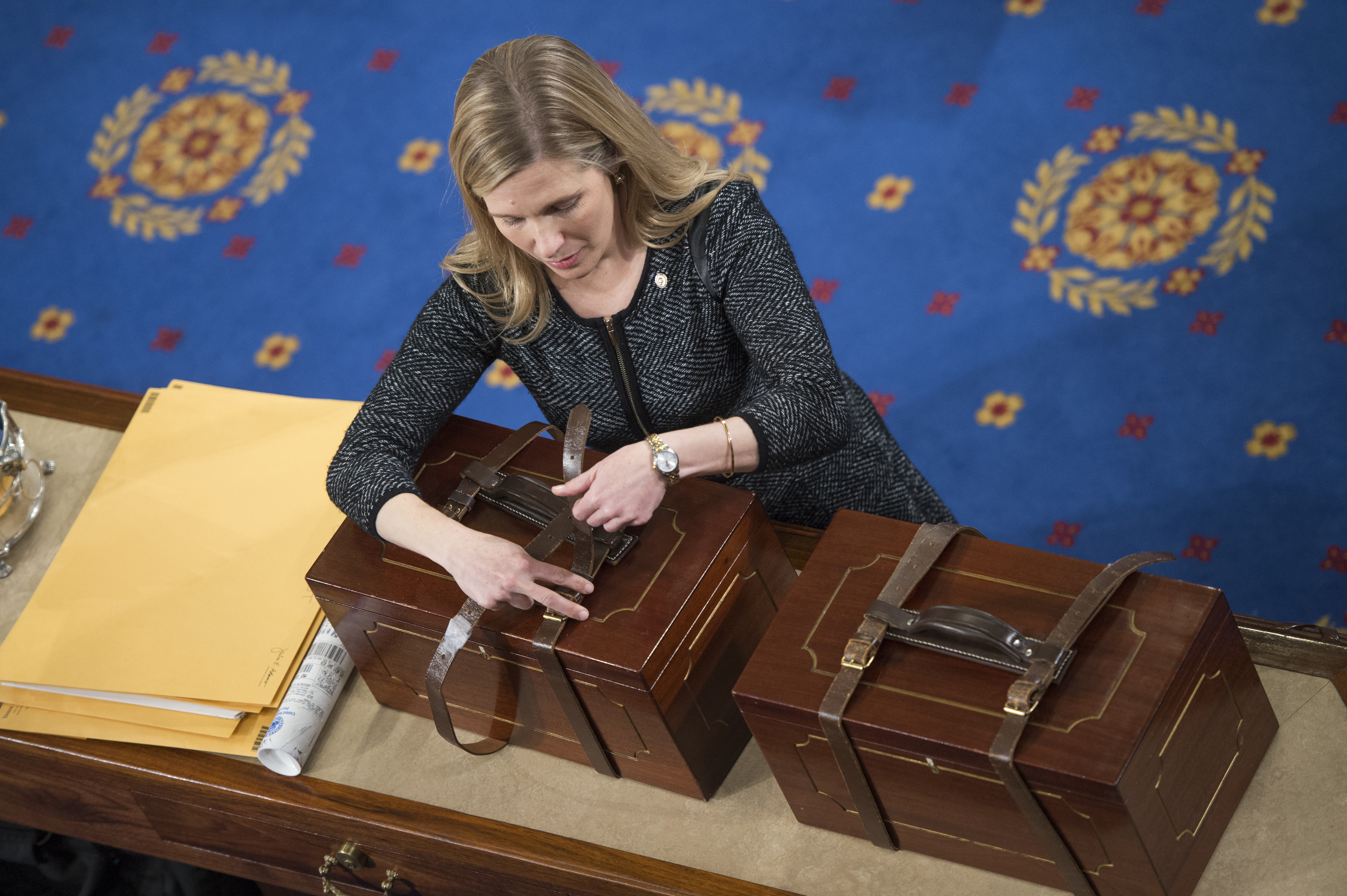 An aide opens Electoral College ballot boxes during a joint session of Congress to tally ballots for the president and vice president of the United States on January 6, 2016.