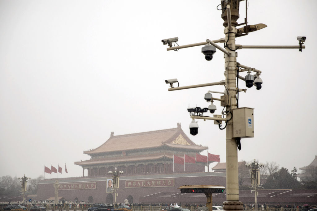 Surveillance cameras are mounted on a post at Tiananmen Square as snow falls in Beijing on Feb. 14, 2019.