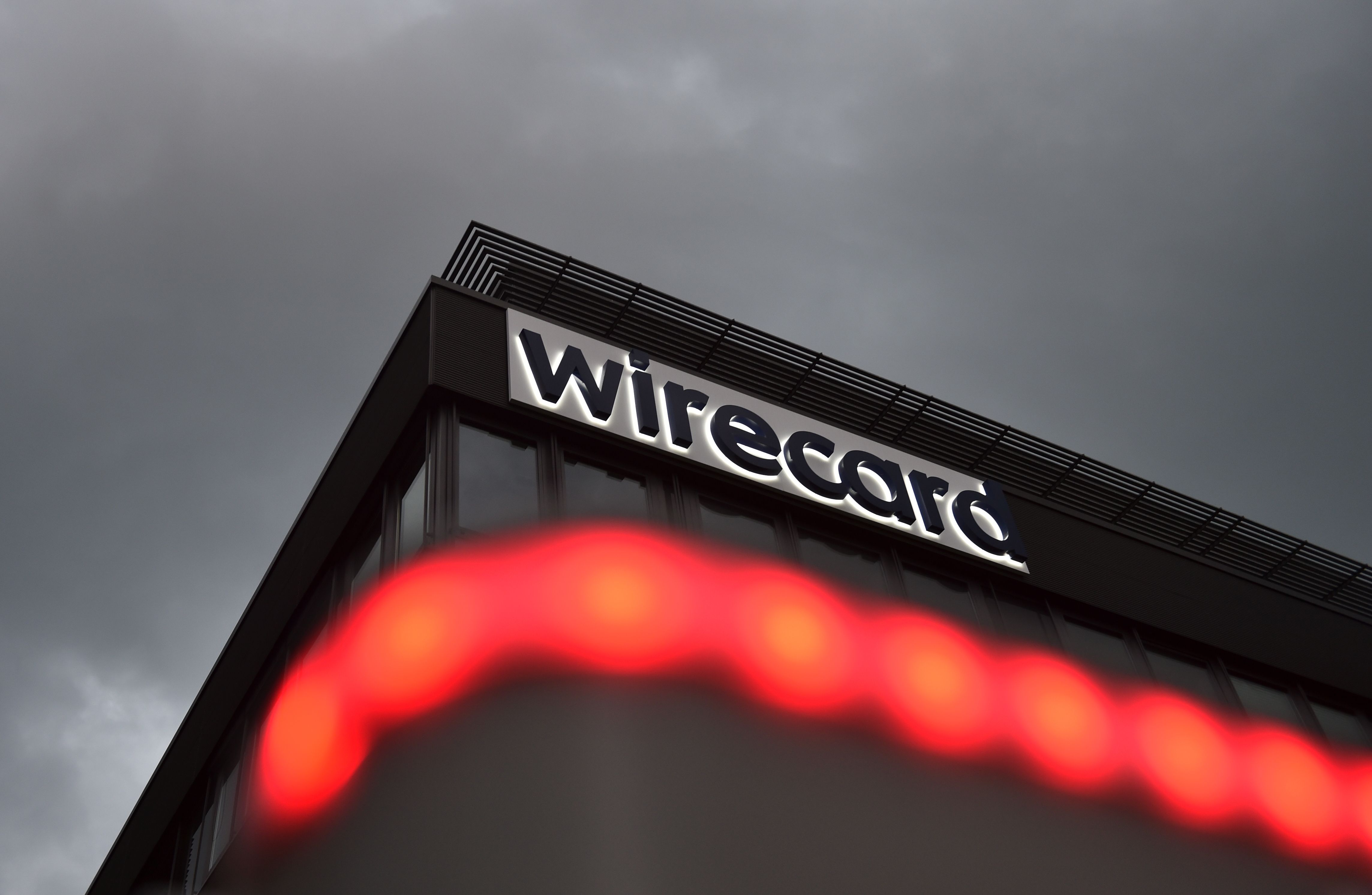 The logo of German payments provider Wirecard is seen at a building of the company's headquarters in Aschheim near Munich, southern Germany, on September 2, 2020. - Germany is poised to launch a full parliamentary inquiry into the collapse of payments provider Wirecard, as questions mount on how the government failed to prevent the country's biggest post-war financial scandal.