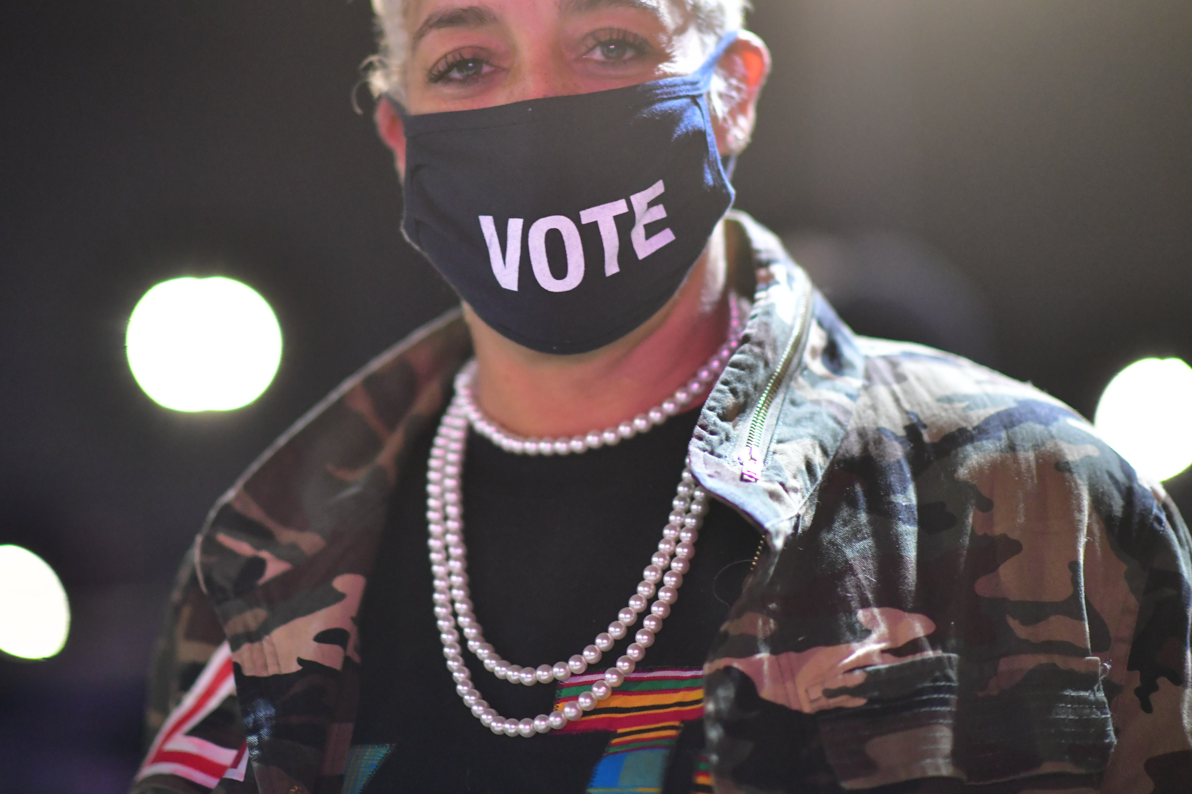Kristen Hart, 47, wears a "VOTE" mask before Democratic vice presidential nominee Sen. Kamala Harris (D-CA) speaks at a drive-in election eve rally on November 2, 2020 in Philadelphia, Pennsylvania.