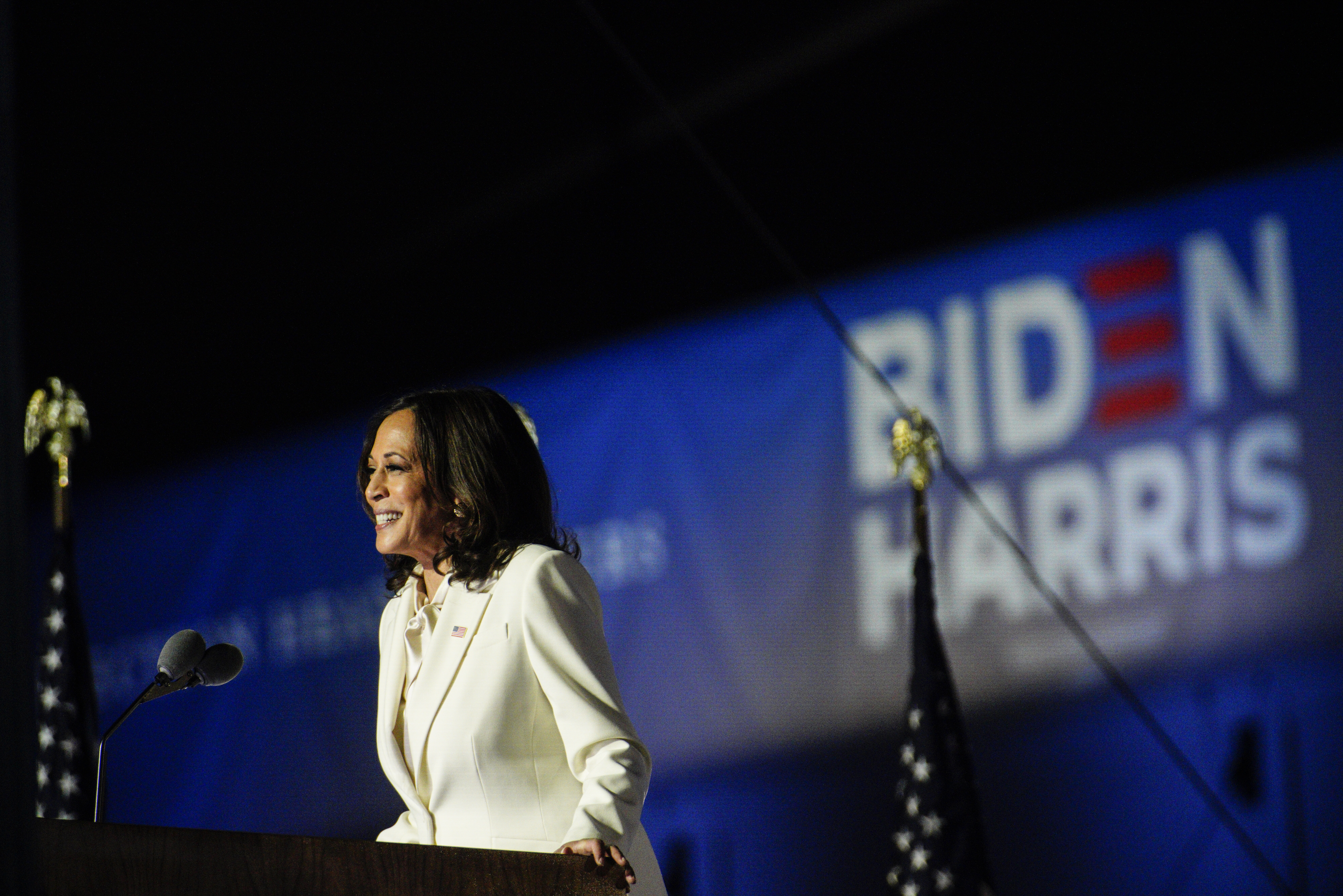 U.S. Vice President-elect Kamala Harris smiles while delivering an address to the nation during an election event in Wilmington, Delaware, U.S., on Saturday, Nov. 7, 2020. Joe Biden defeated Donald Trump to become the 46th U.S. president, unseating the incumbent with a pledge to unify and mend a nation reeling from a worsening pandemic, faltering economy and deep political divisions. 