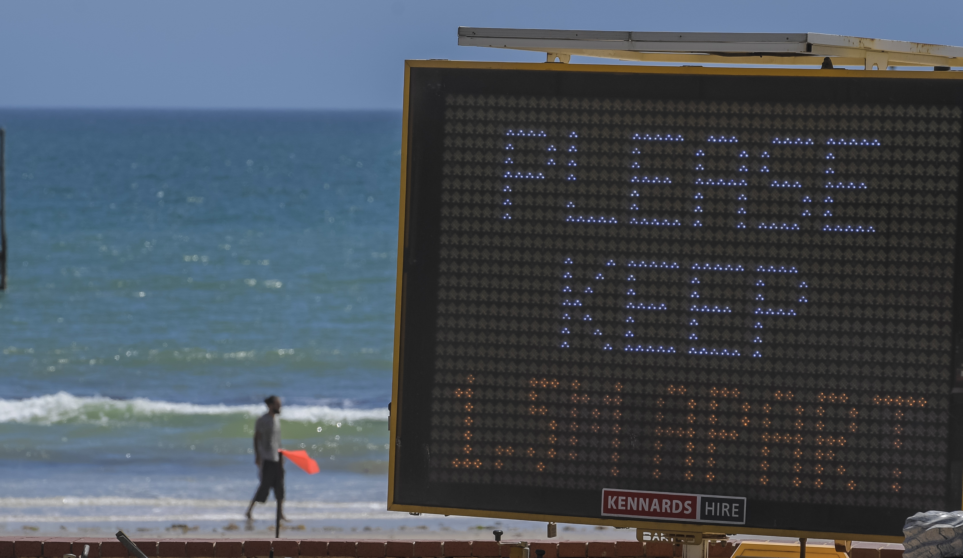 A man is seen by the water's edge at Glenelg Beach on November 19, 2020 in Adelaide, Australia. A tight lockdown will end early after fears about a new strain of the virus proved unfounded.