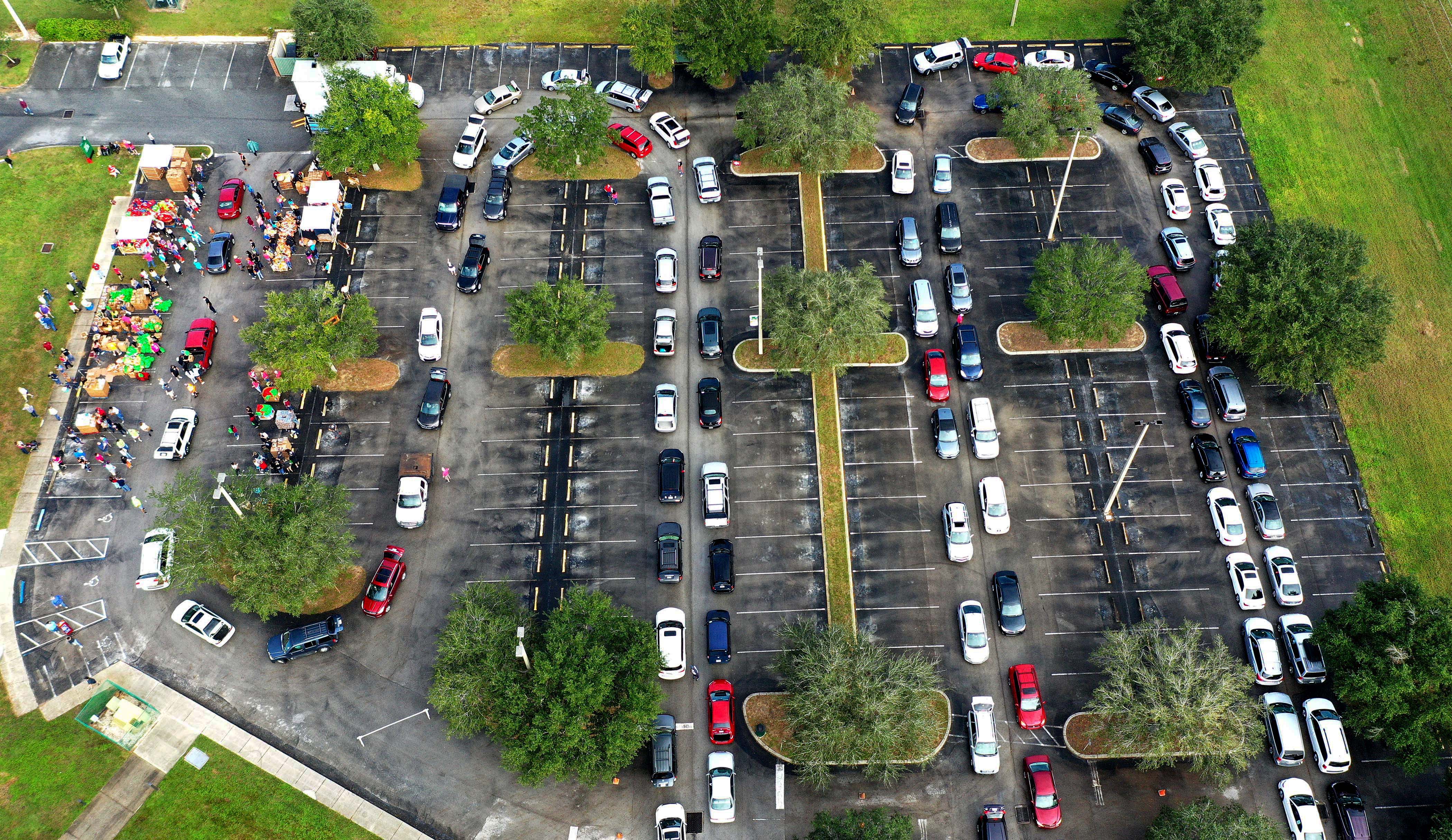 Residents line up in their cars at a food distribution site at Lake-Sumter State College sponsored by the Second Harvest Food Bank of Central Florida and local churches.
With the approach of Thanksgiving, thousands of families in the Orlando area are in need of food assistance due to COVID-19 related layoffs in the tourist industry and the expiration of supplemental federal unemployment benefits. 