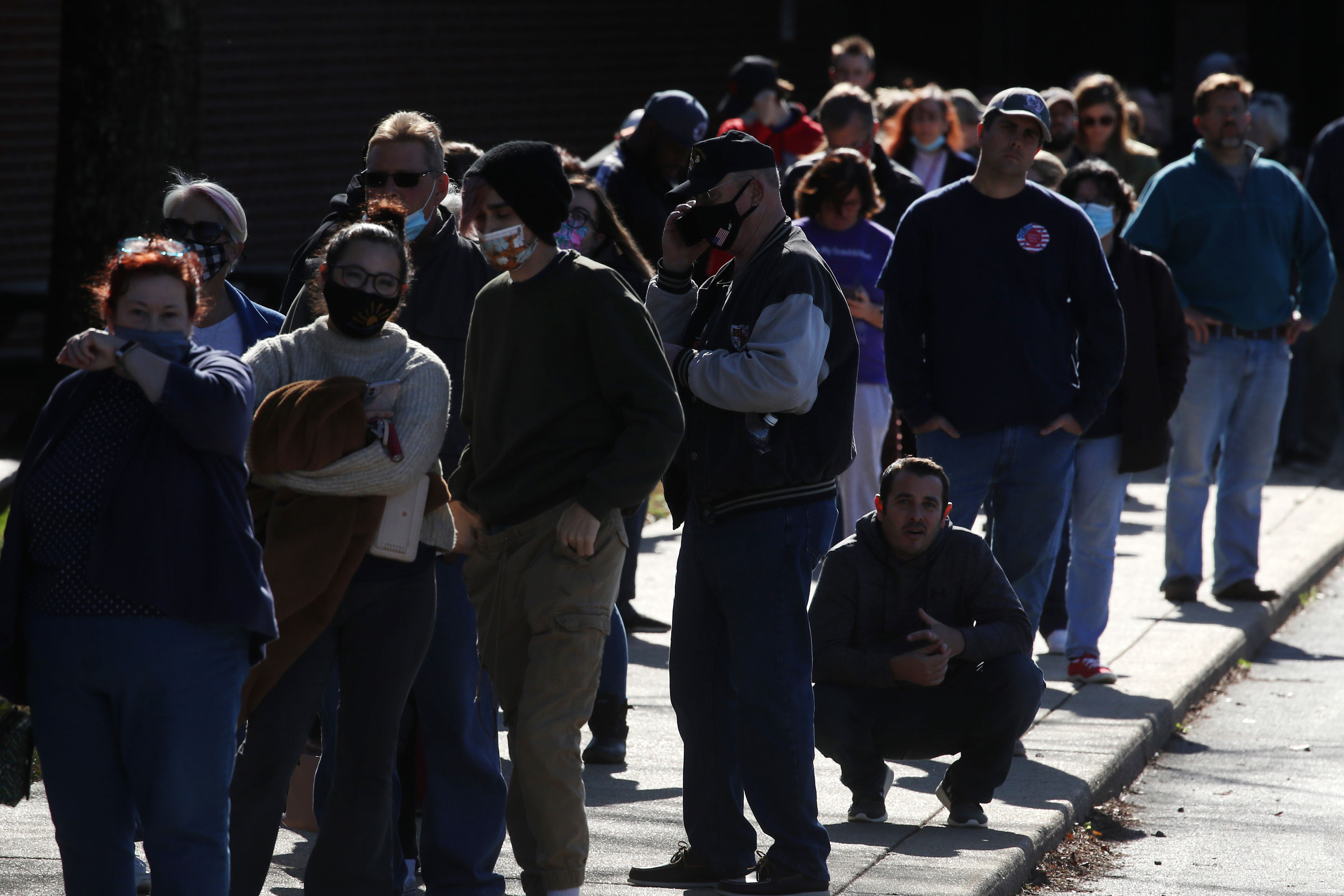 People wait in line to cast their votes at Northern High School in Owings, Md., on Election Day.