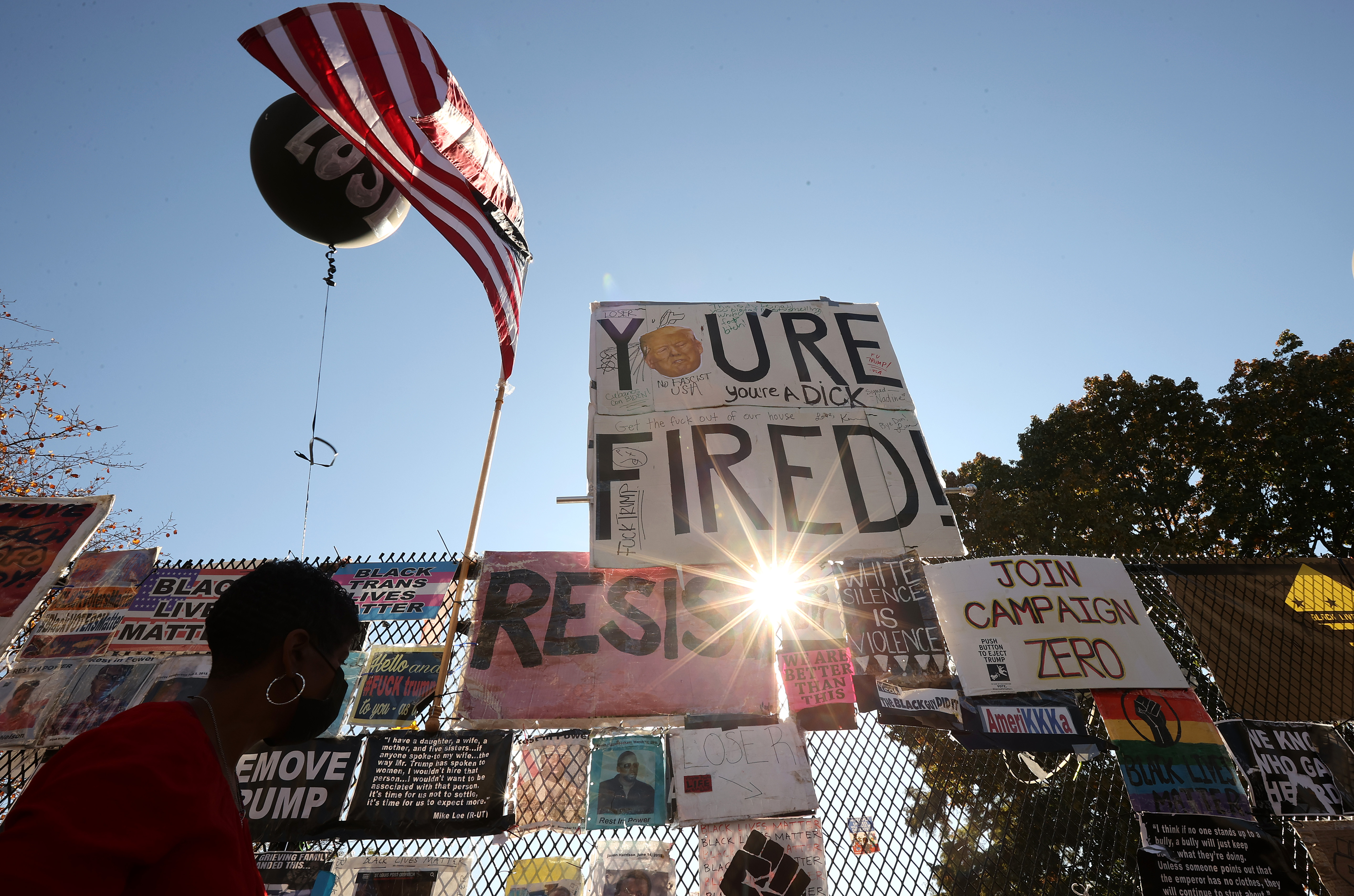 Supporters of U.S. President-elect Joe Biden and his running mate Vice President-elect Kamala Harris continue to celebrate and gather near the security fence that surrounds the White House.