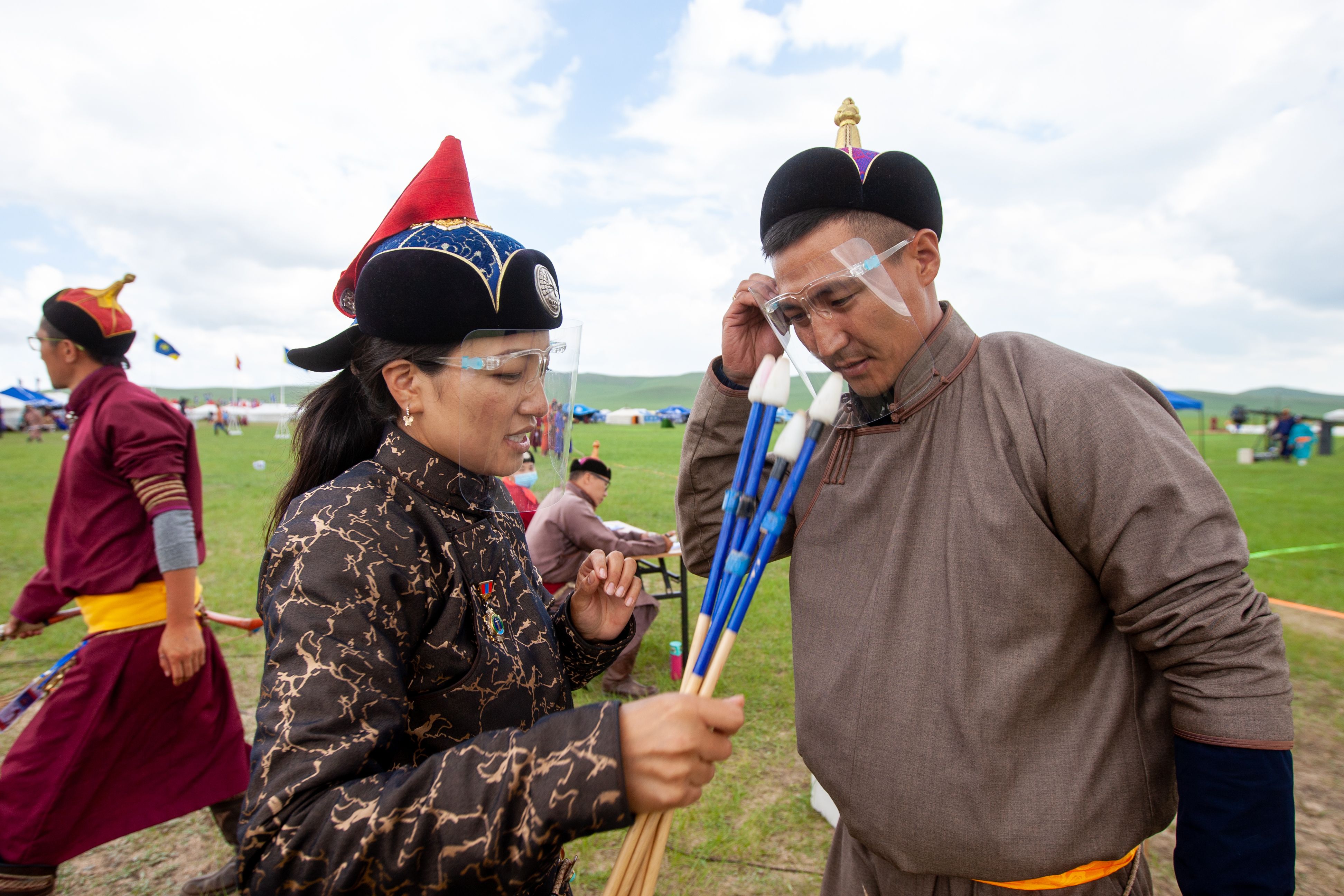 Judges wear face shields during an archery competition at the annual Naadam sports festival near Ulaanbaatar, Mongolia.