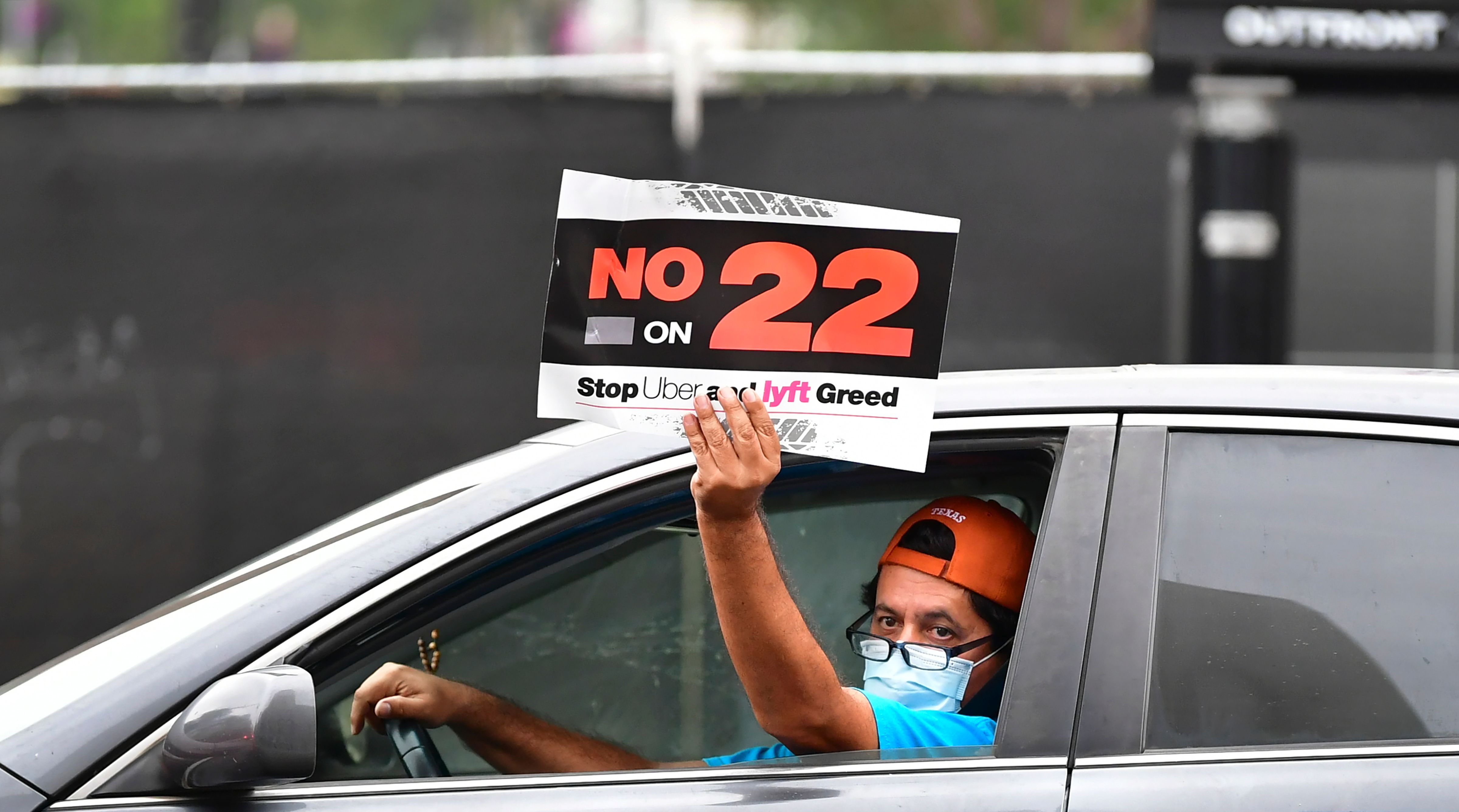 A driver taking part in an October protest at City Hall in Los Angeles to oppose Proposition 22, a California ballot measure that classified app-based drivers as independent contractors and not employees. The measure passed, upholding the business model of ride-hailing companies like Uber and Lyft.