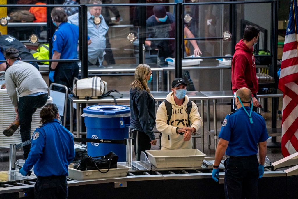 Travelers pass through security screening at Seattle-Tacoma International Airport on November 29, 2020 in SeaTac, Washington. Public health experts warn that COVID-19 cases may surge following holiday travel, as the U.S. surpasses 4 million cases so far this month.