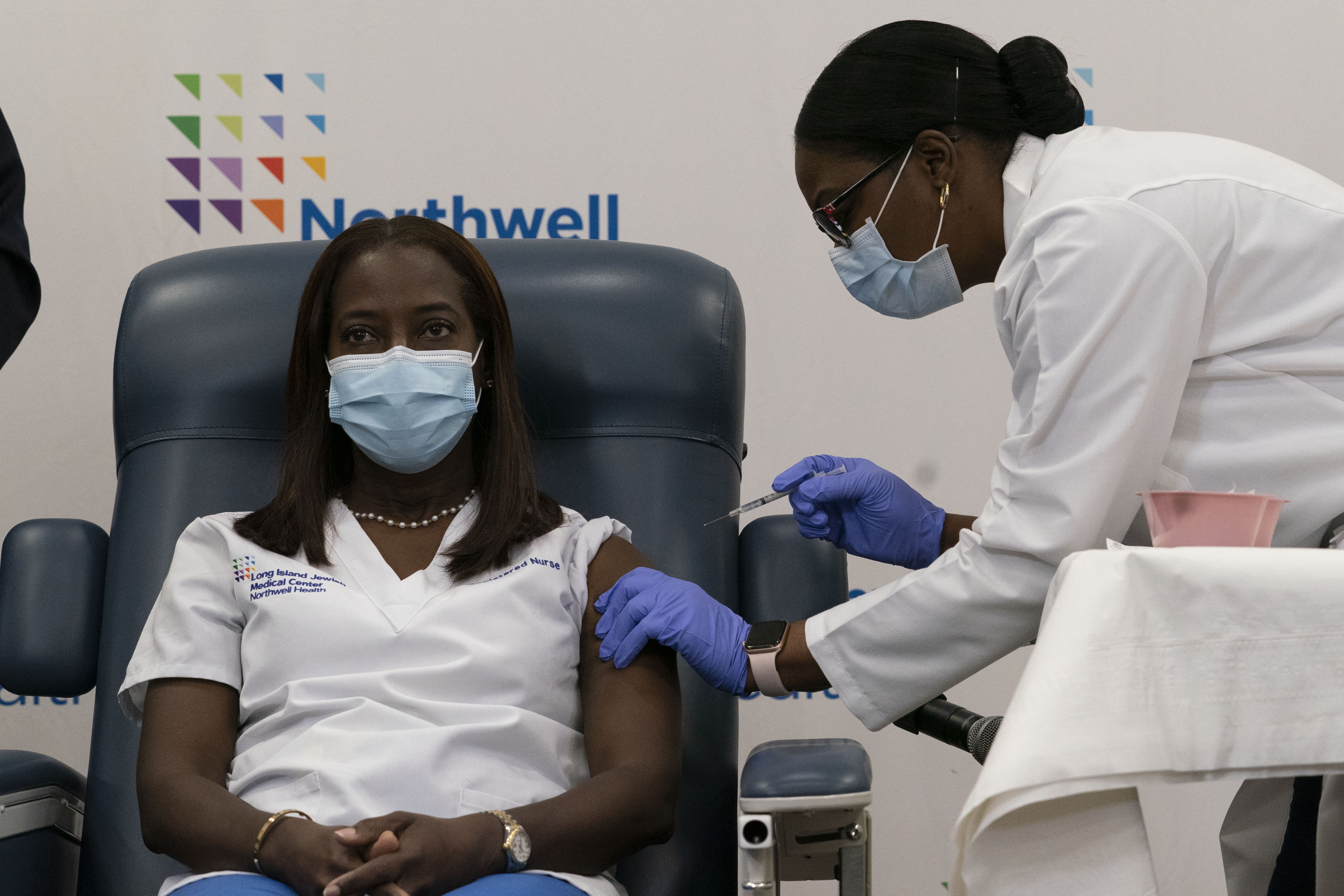 Sandra Lindsay (left), a nurse at Long Island Jewish Medical Center, is inoculated with the COVID-19 vaccine by Dr. Michelle Chester, at Long Island Jewish Medical Center on Dec. 14, 2020.