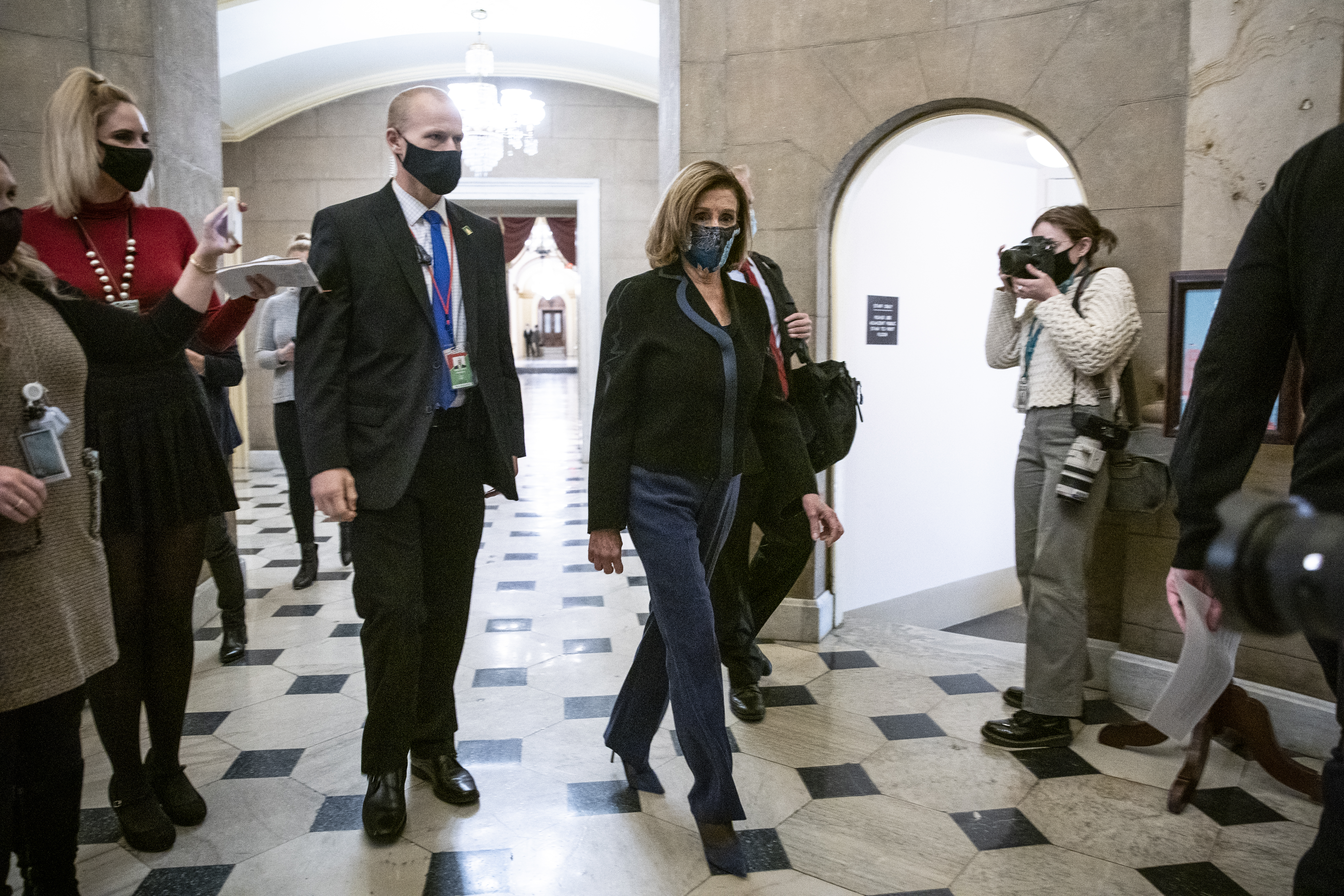U.S. House Speaker Nancy Pelosi, a Democrat from California, walks from the House floor to her office in the U.S. Capitol in Washington, D.C., U.S., on Wednesday, Dec. 16, 2020. The top congressional leaders from both parties are close to agreement on a Covid-19 relief package worth less than $900 billion, which they hope to attach to crucial government spending legislation and pass by the end of the week, according to two people familiar with the discussions.