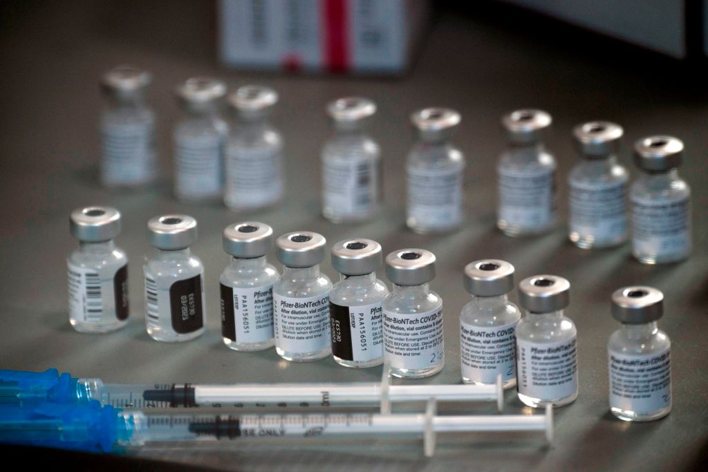 Syringes wand vials of the Pfizer-BioNTech COVID-19 vaccine are prepared to be administered to front-line health care workers under an emergency use authorization at a drive up vaccination site from Renown Health in Reno, Nev. on December 17, 2020.