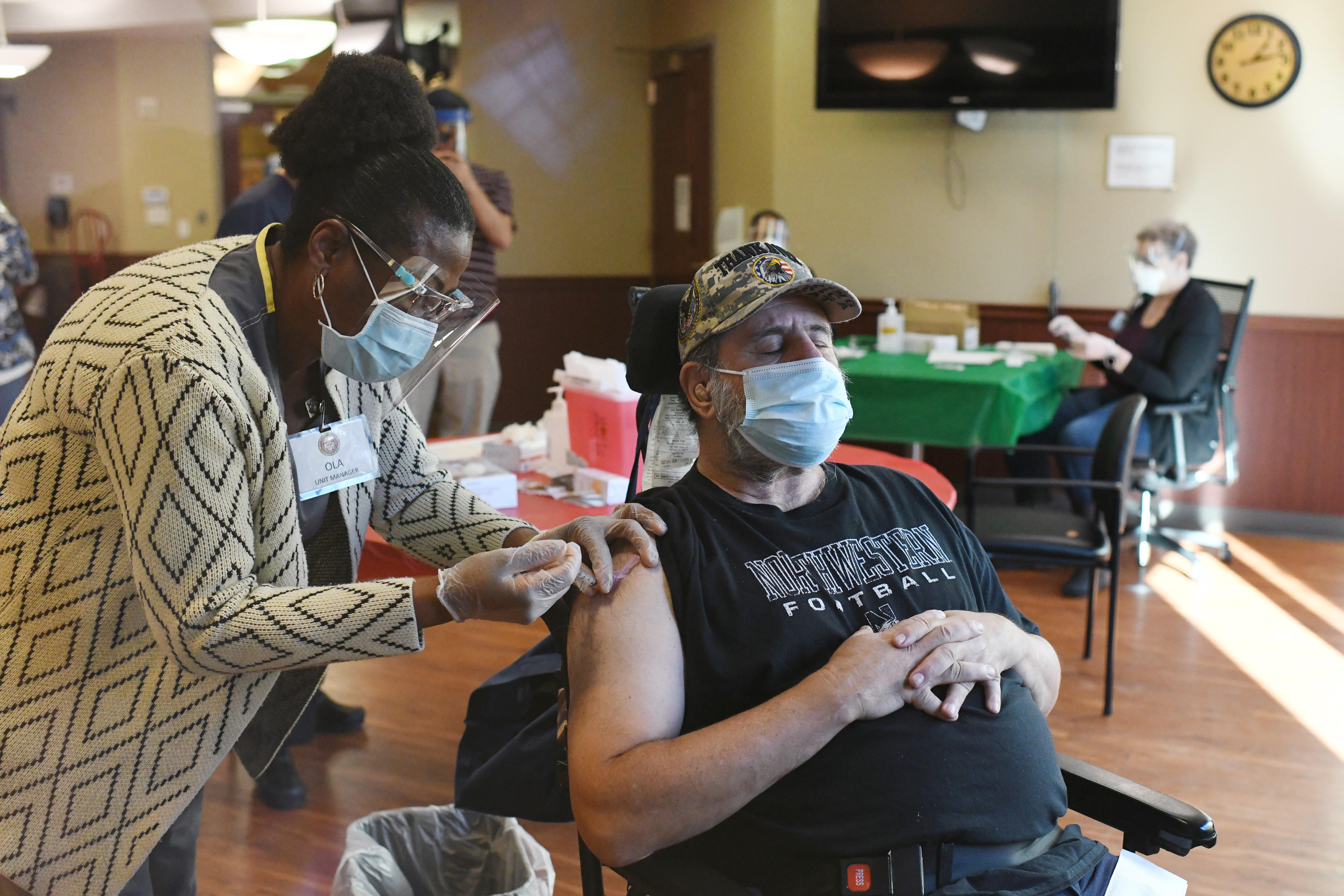 Army veteran Phil Ross, 73, receives a COVID vaccine at Veterans Community Living Center at Fitzsimons in Aurora, Colo., on Dec. 22, 2020. Disabled Americans are among the groups facing barriers to accessing the second dose of a two-dose vaccine, according to a new study.