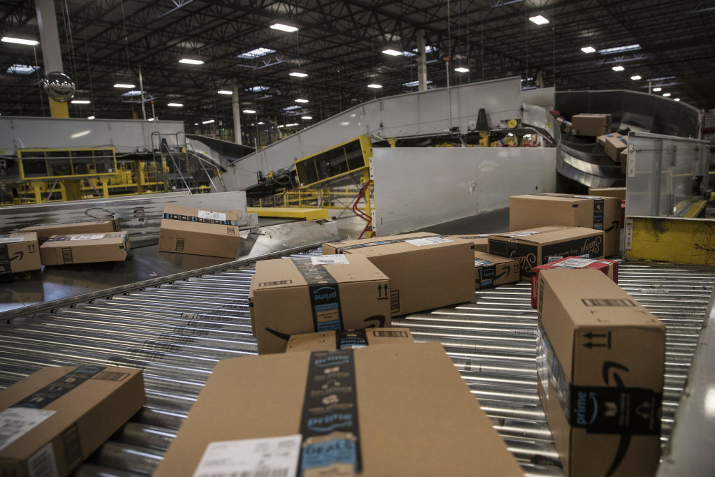 Packages move along a conveyer belt at the Amazon fulfillment center in Robbinsville, New Jersey, U.S., on Monday, Nov. 27, 2017.