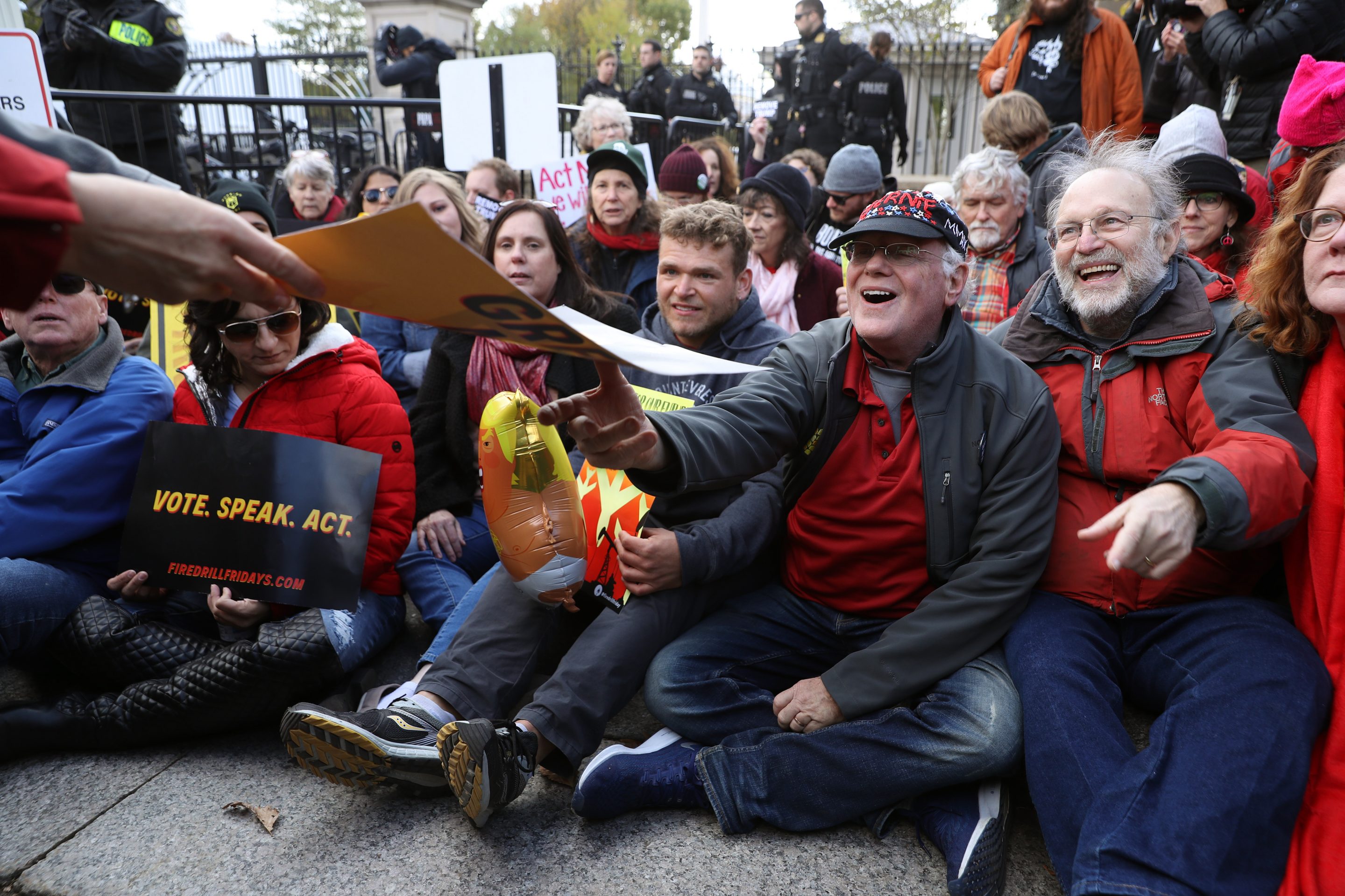 Jerry Greenfield (2nd R) and Ben Cohen (3rd R), co-founders of Ben and Jerry's, join about 20 people sitting in front of the White House northwest gate as part of a "Fire Drill Fridays" rally protesting climate change November 08, 2019 in Washington, D.C.