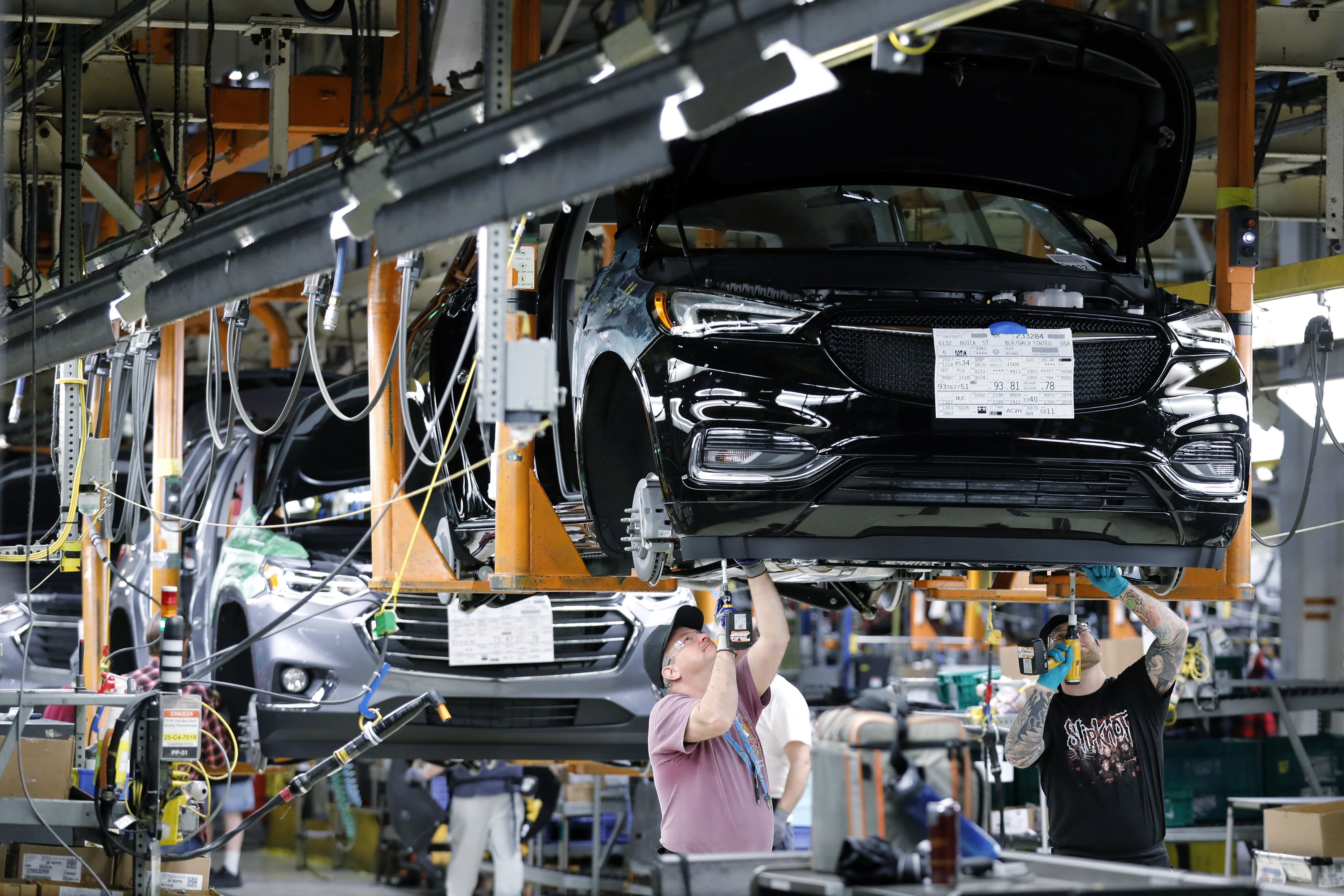 Employees install components on a General Motors vehicle at a factory in Lansing. Enforcing fair trade rules in the auto industry and many others is “a straightforward, bipartisan way to create and protect American jobs,” writes Jim McCrery.
