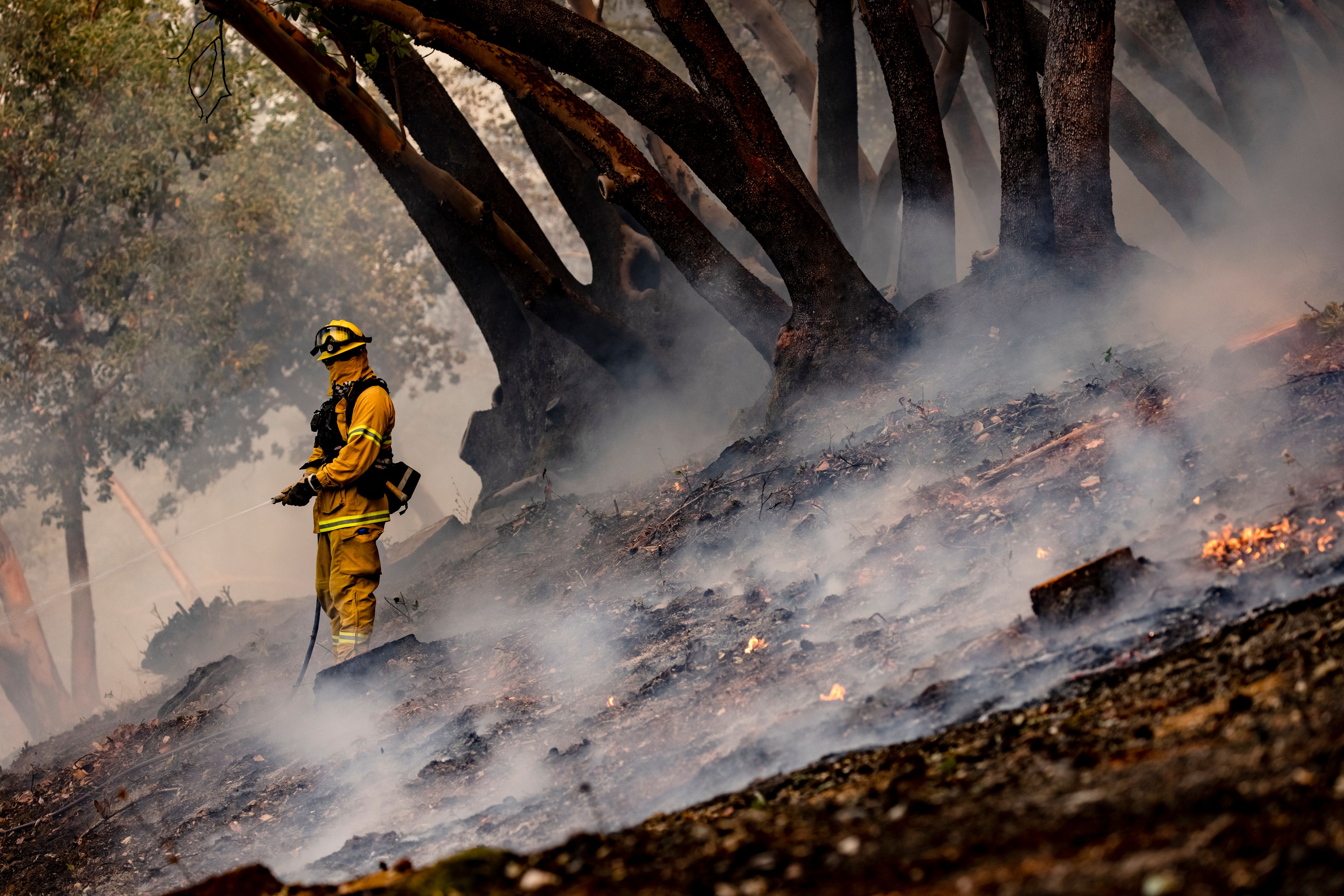 Firefighters with Hilton Cal Fire set a protection burn at the edge of a home and vineyard to protect them from the advance of the Glass Fire, which started in the early morning hours of Sept. 27, 2020, in Napa Valley, Calif. Europe’s climate service says 2020 is tied for the hottest year on record.