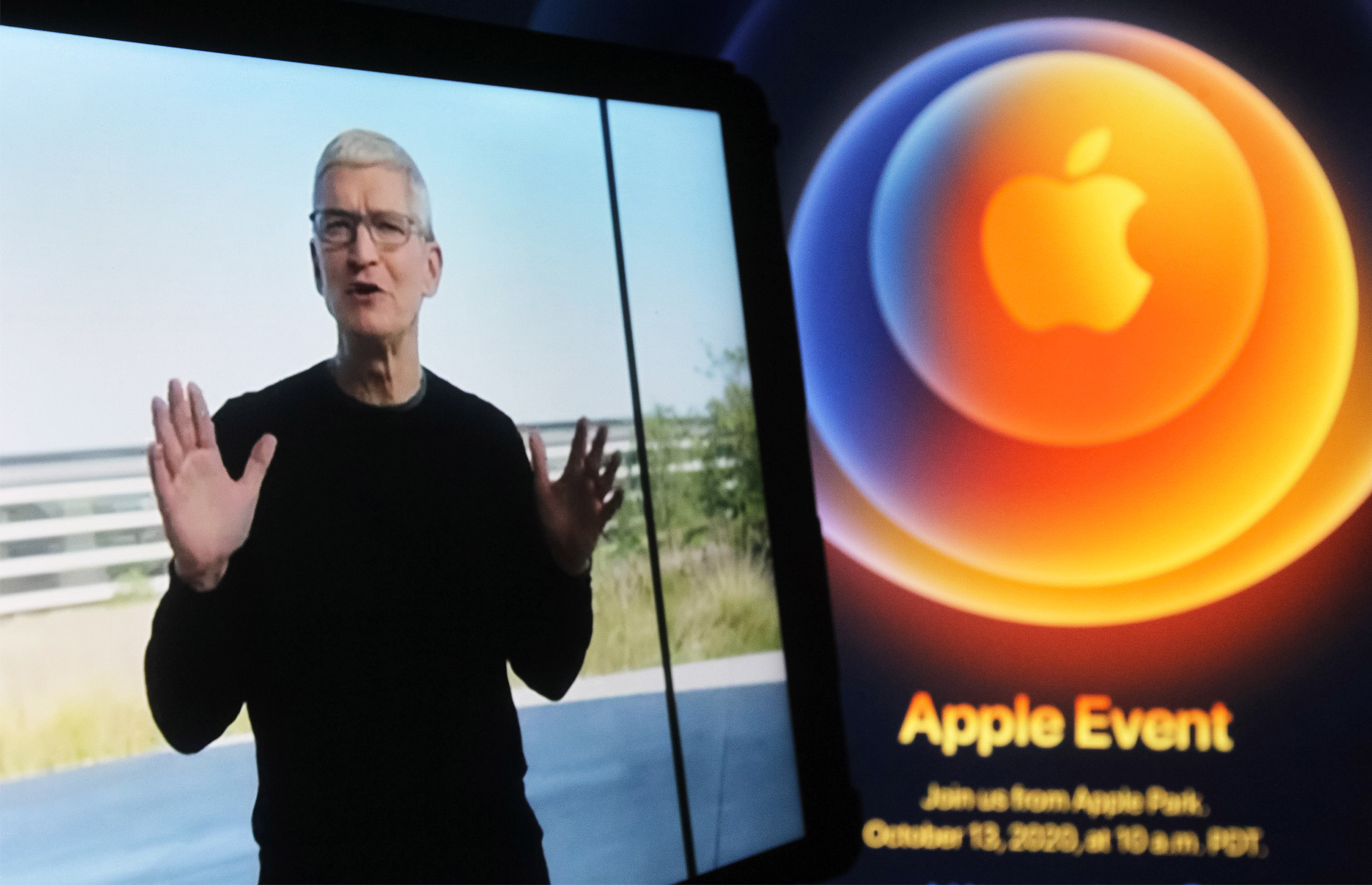 In this photo illustration a screenshot of Apple's CEO Tim Cook from Apple's launch promotional material of the the new iPhone12 seen displayed on a iPad tablet screen with the Apple logo in the background. Analysts expect Apple to post its best earnings results ever for the first quarter of its fiscal year 2021 on Wednesday.