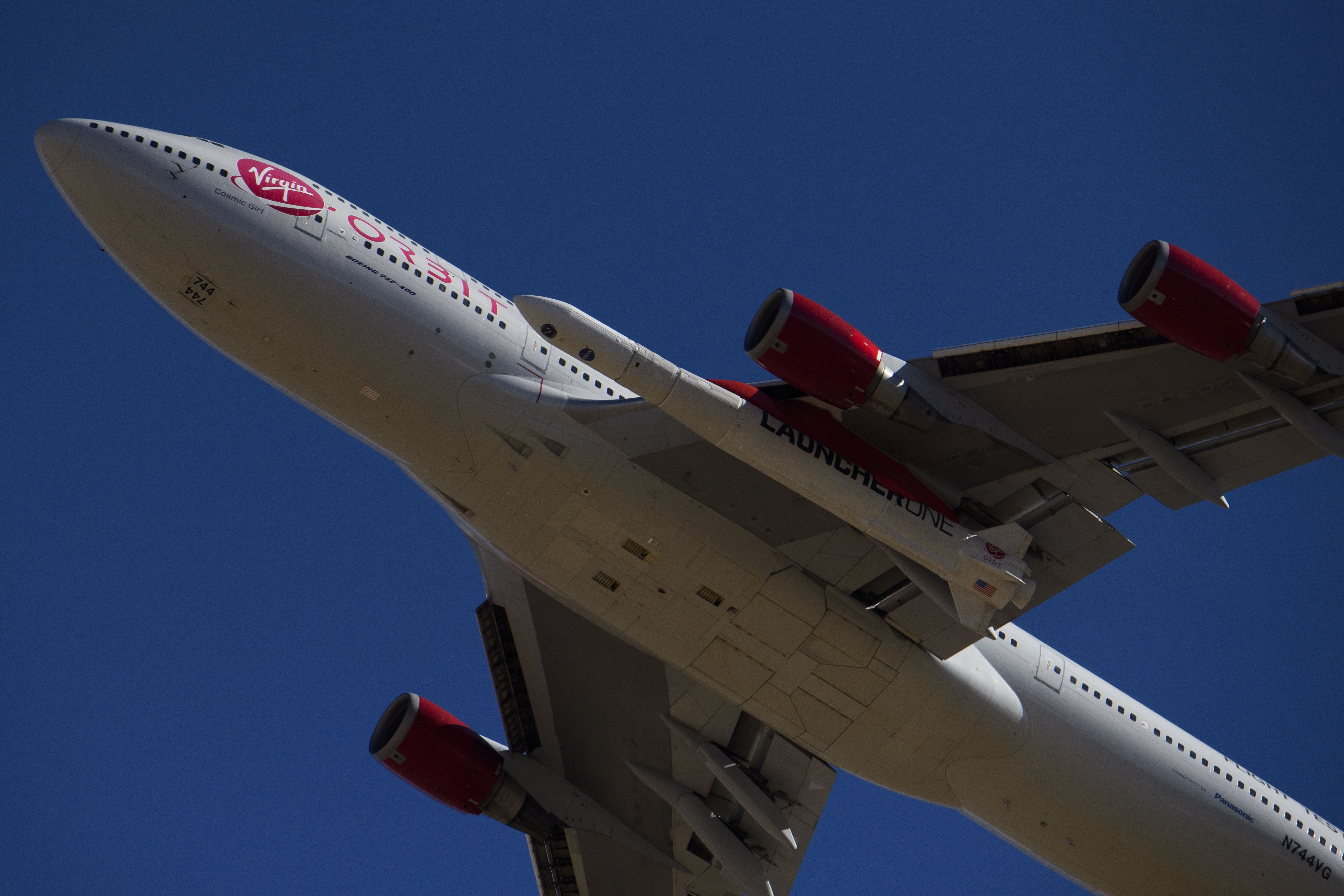 A Virgin Orbit 747-400 carrying a LauncherOne rocket under its wing.