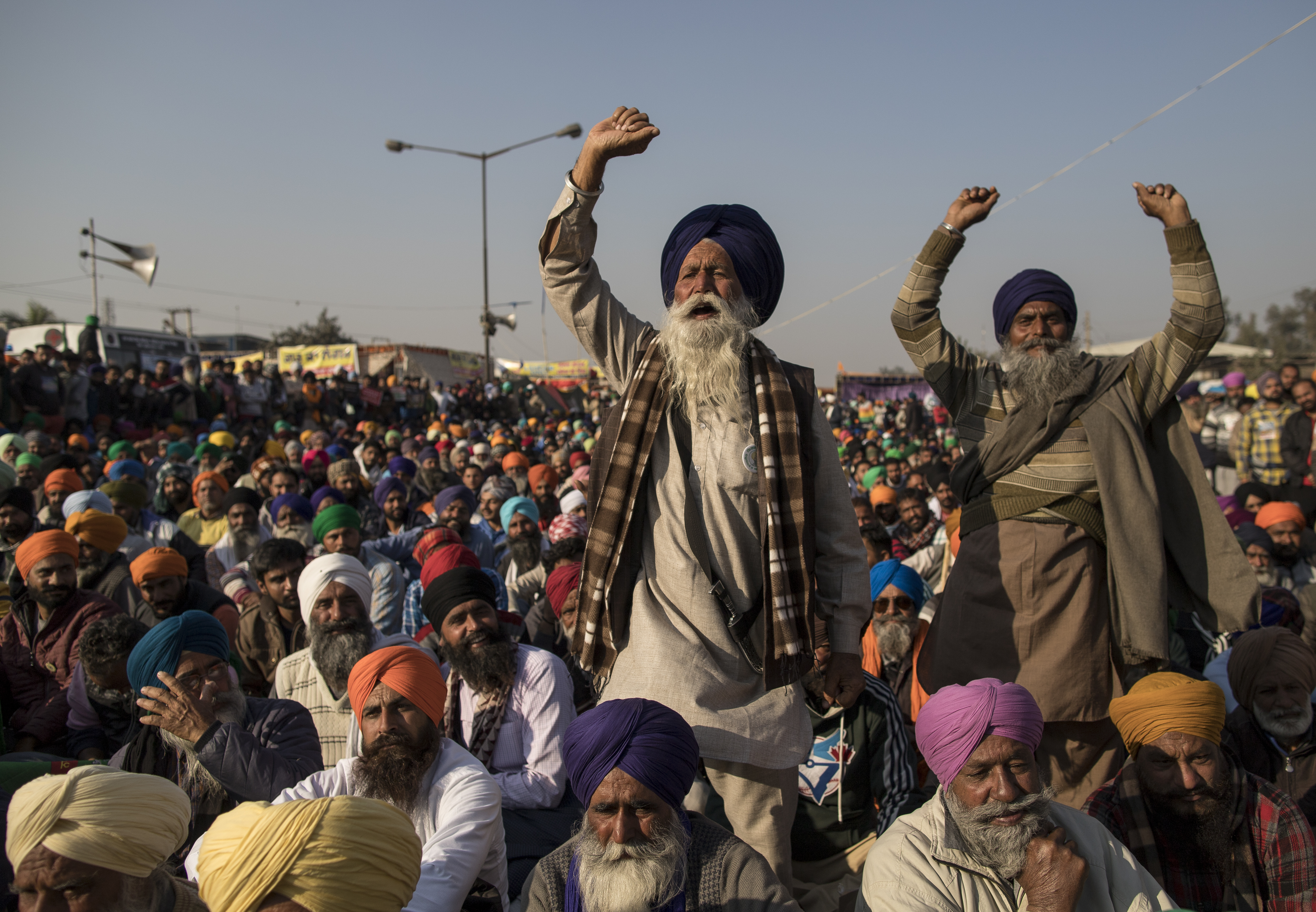 Farmers shout slogans as they participate in a protest at the Delhi Singhu border on Dec. 18, 2020 in Delhi, India.