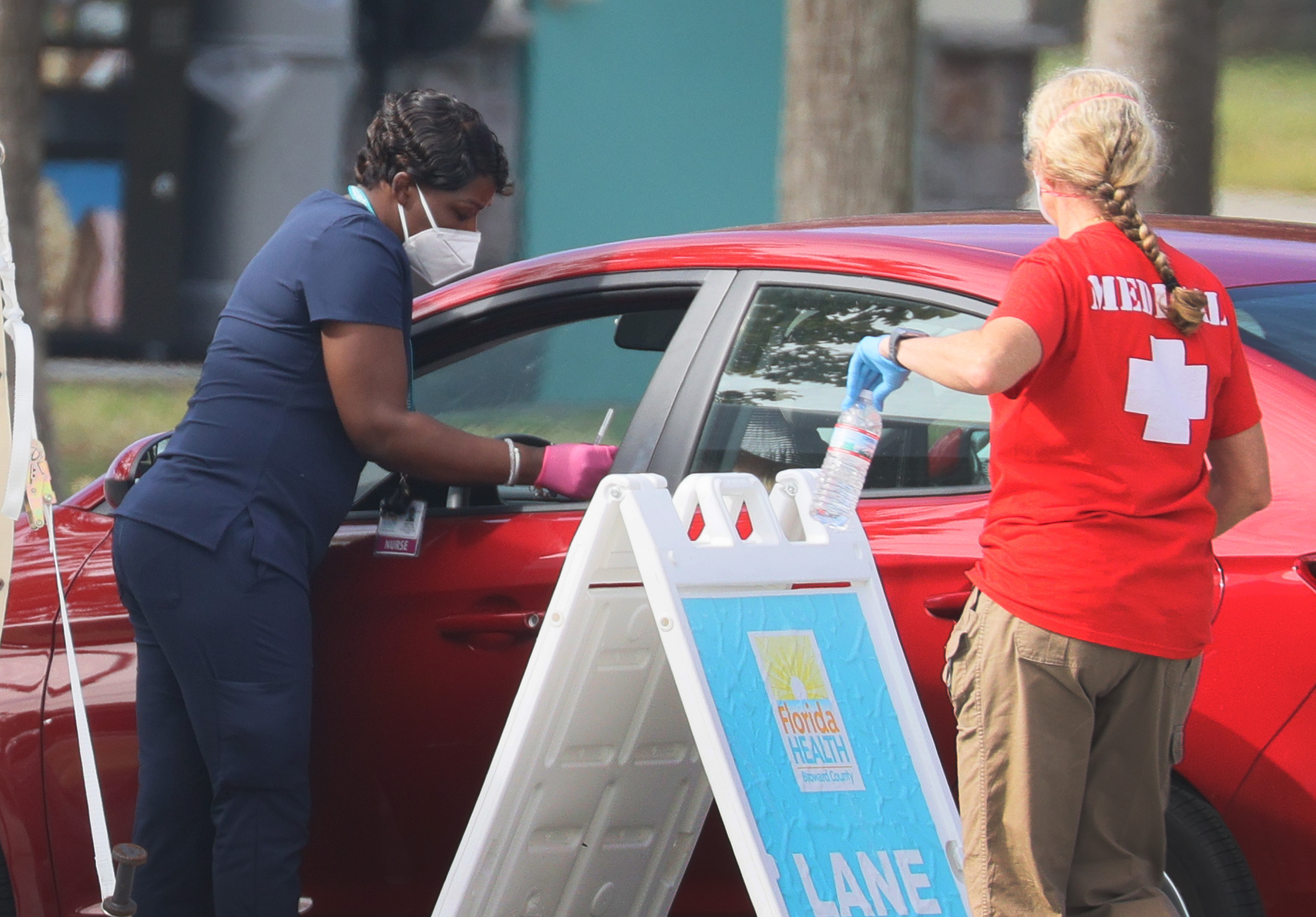 A healthcare worker prepares to administer a COVID-19 vaccine at a drive-thru vaccination site on Jan. 4, 2021 in Davie, Fla.