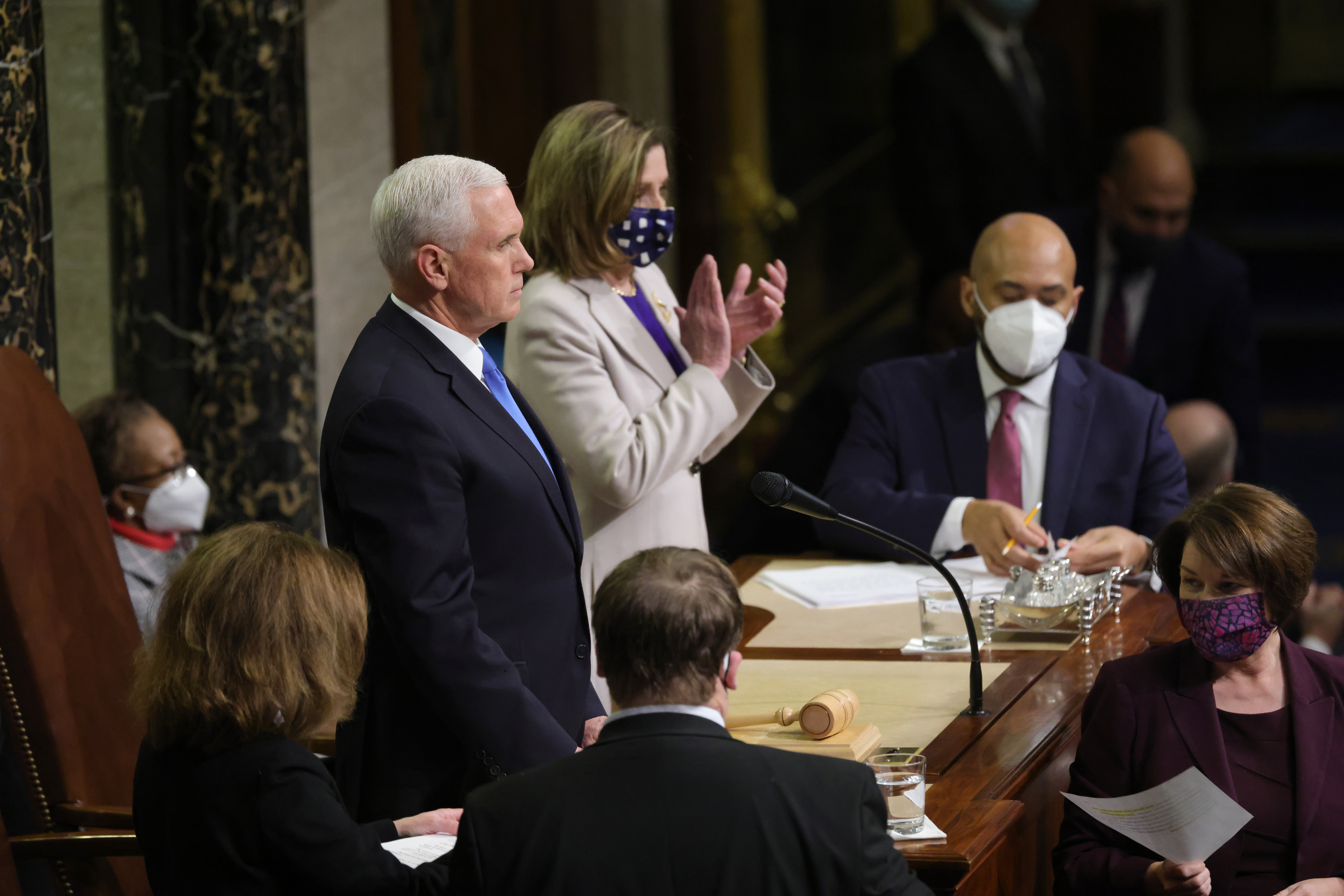Vice President Mike Pence (L) and U.S. Speaker of the House Nancy Pelosi (D-CA) look on as the the count of electoral votes continues in the House Chamber during a reconvening of a joint session of Congress on January 07, 2021 in Washington, DC. Members of Congress returned to the House Chamber after being evacuated when protesters stormed the Capitol and disrupted a joint session to ratify President-elect Joe Biden's 306-232 Electoral College win over President Donald Trump.