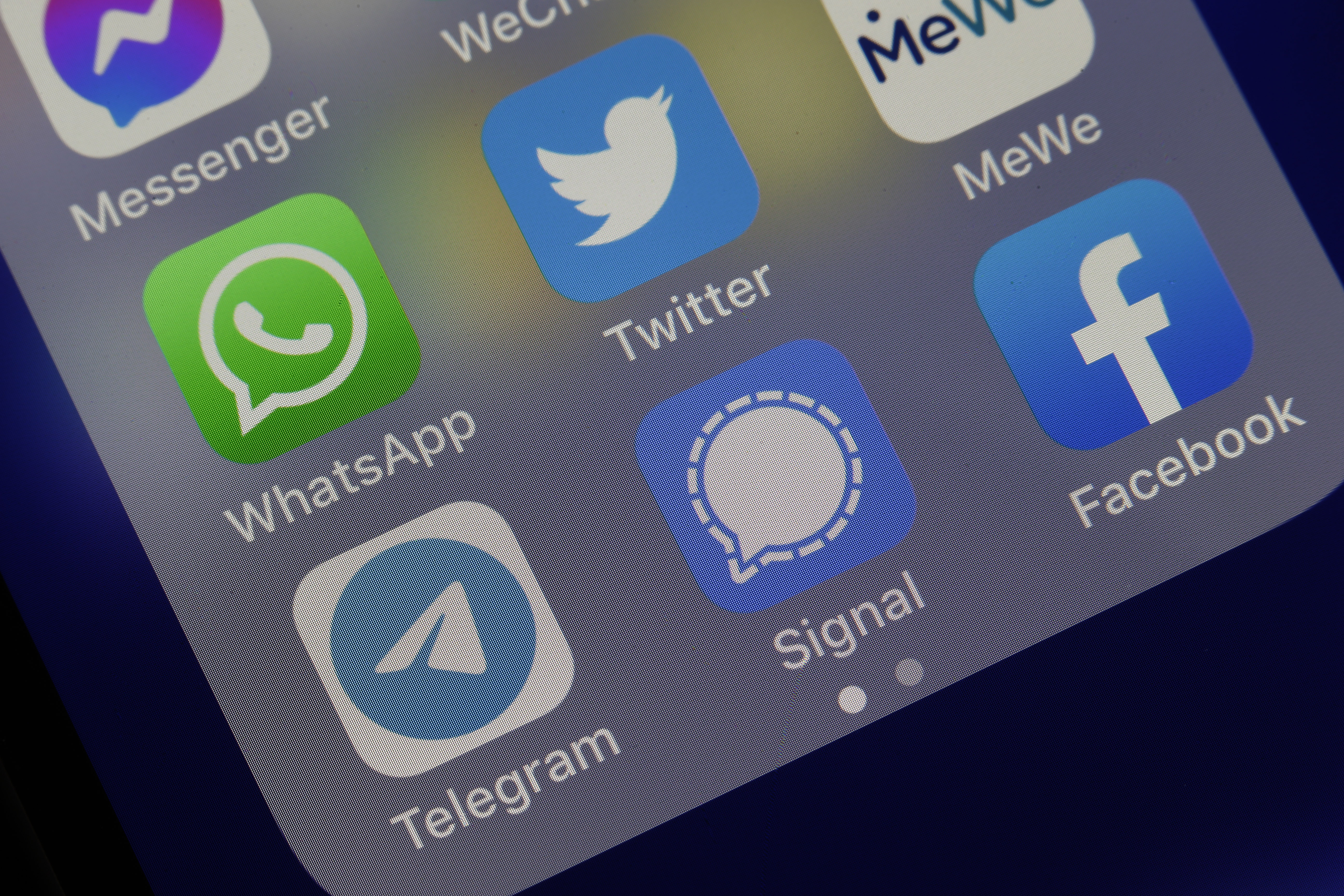 In this photo illustration, the logos of social media applications Messenger, WhatsApp, Twitter, MeWe, Telegram, Signal and Facebook are displayed on the screen of an iPhone on January 13, 2021 in Paris, France.