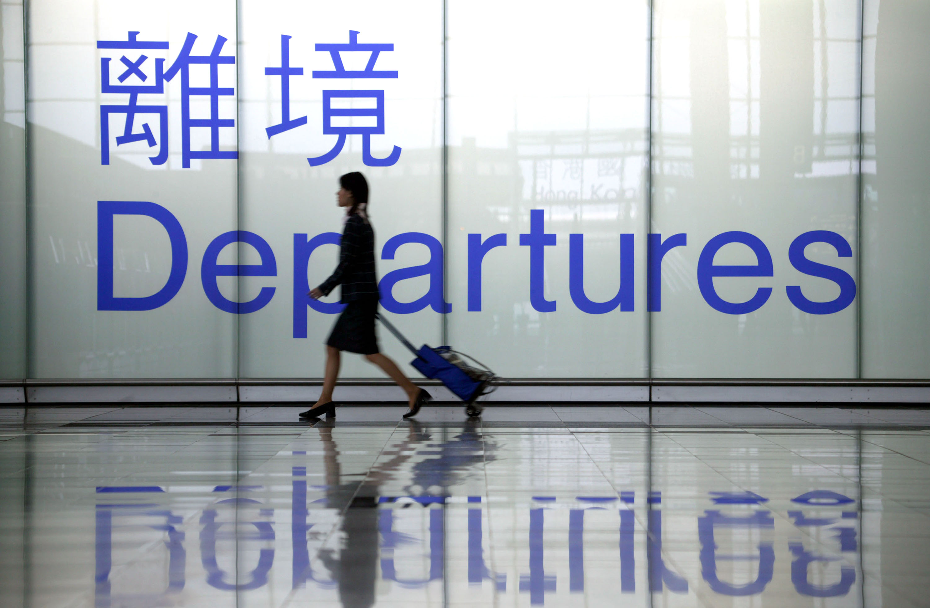 An airline stewardess heads towards a departure gate at Chek Lap Kok airport March 7, 2003 in Hong Kong.