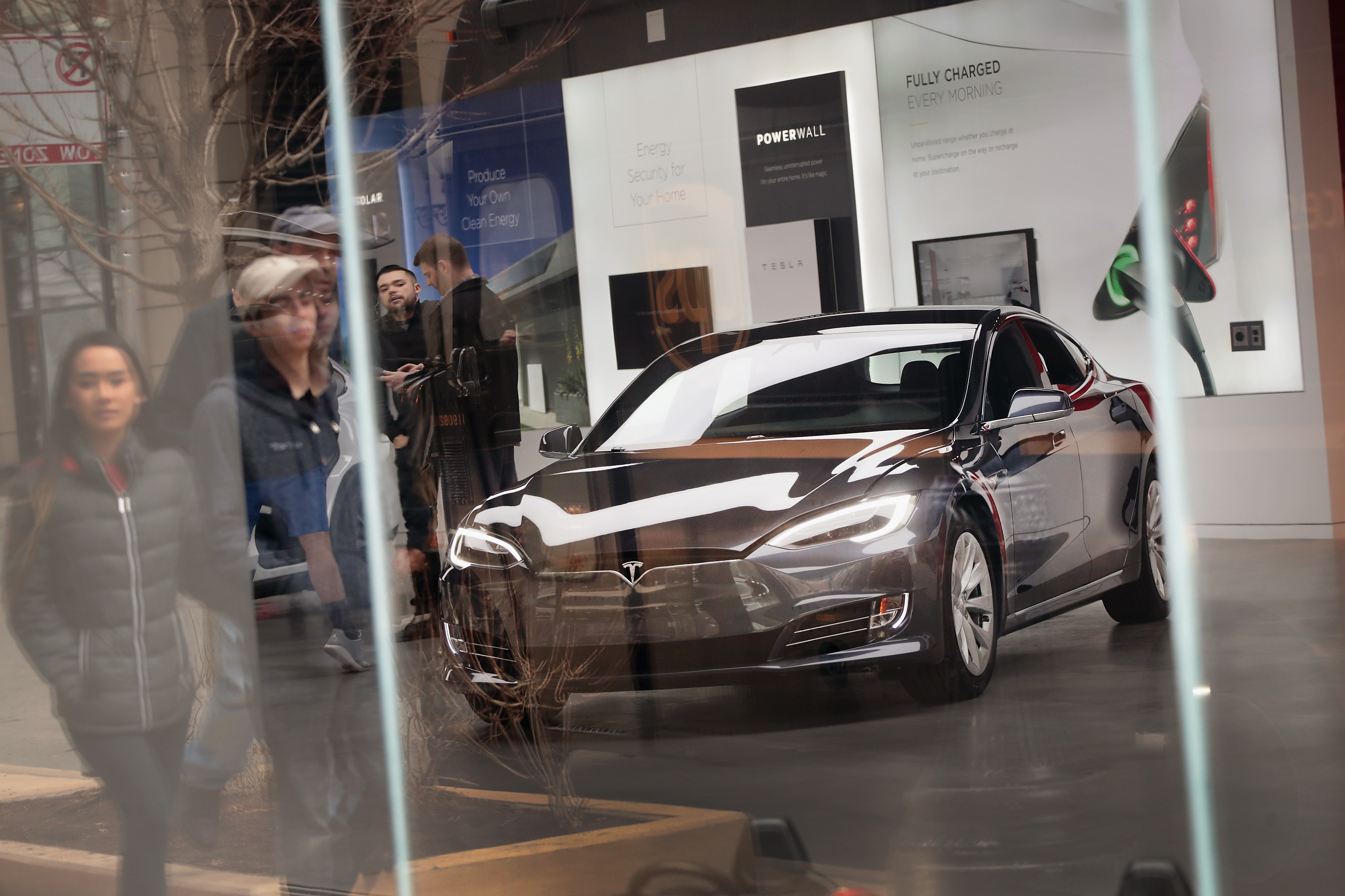 A Model S sits on the showroom floor at a Tesla dealership.