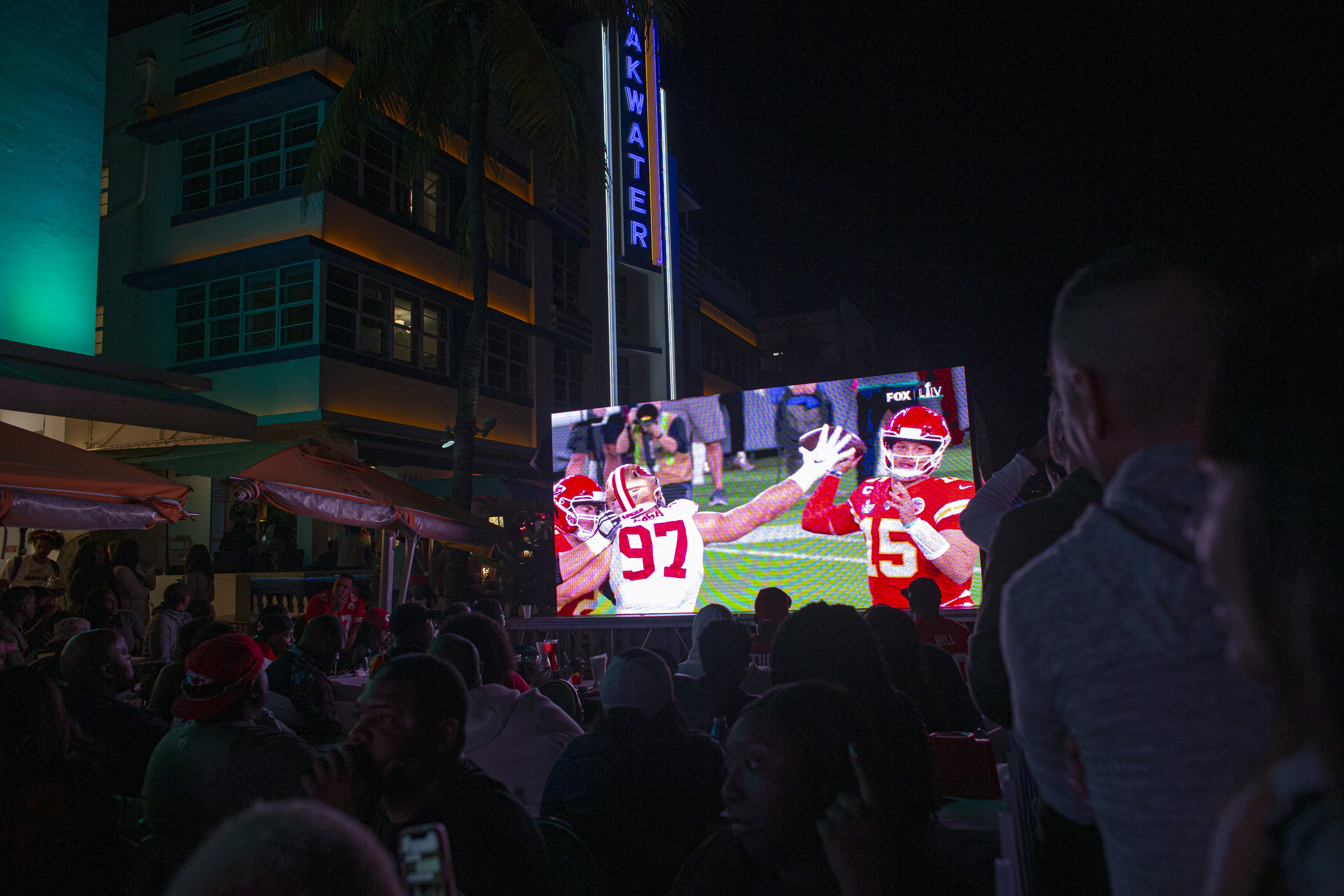 Fans watch the broadcast of Super Bowl XLIV on a beachfront screen in Miami.