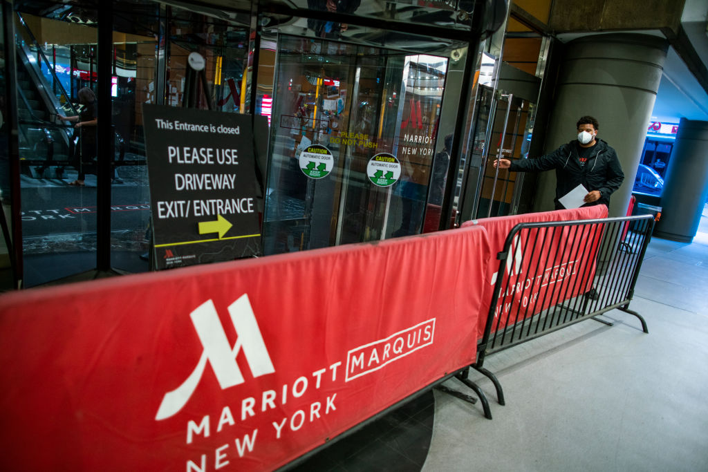 A person try to go inside of one of the entrance of the International Hotel Marriott Marquis while it was closed during the outbreak of the COVID-19 pandemic on May 21, 2020 in New York City.