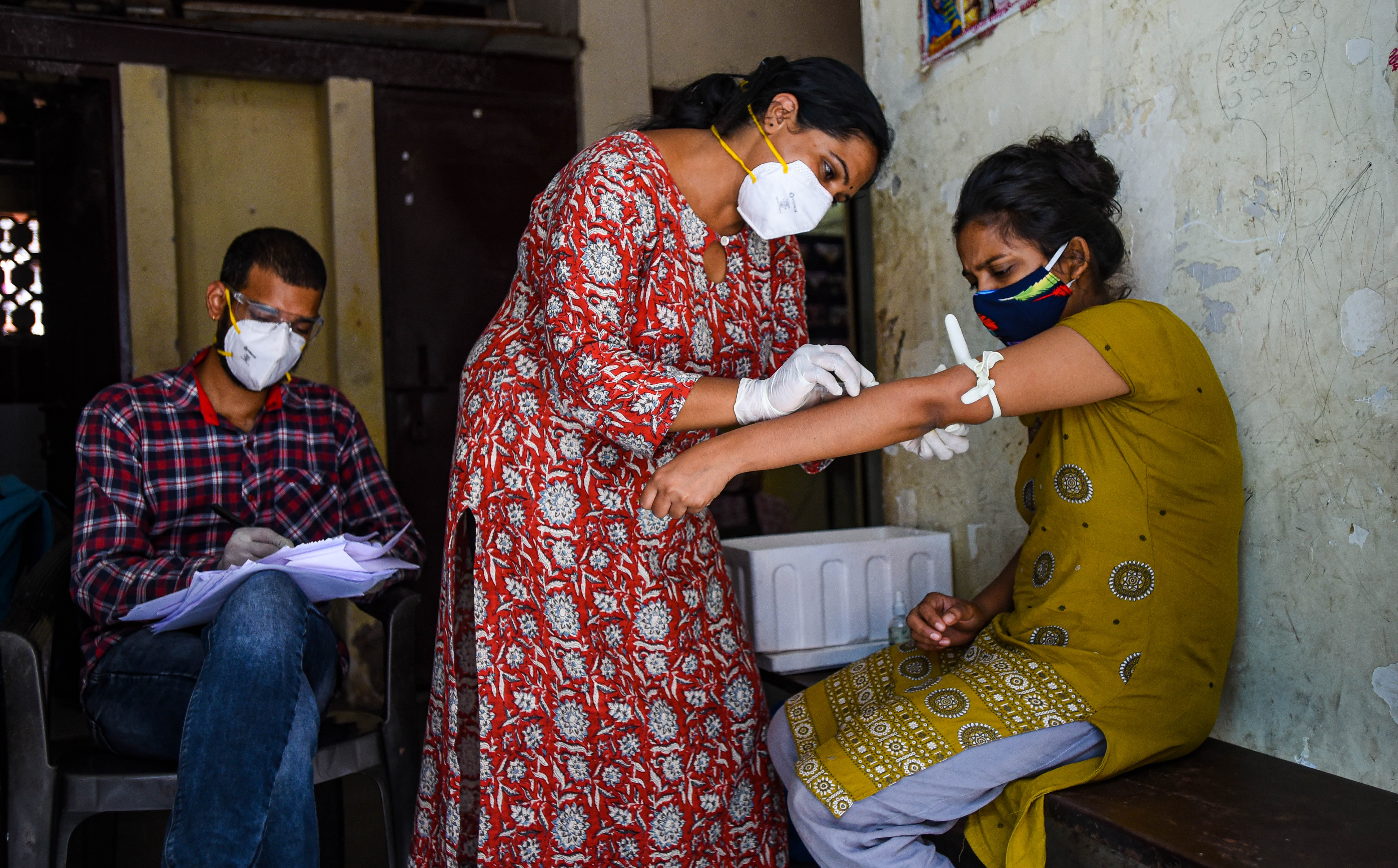 A health worker draws a blood sample in the third round of serological survey testing for the coronavirus on Sept. 3, 2020, in New Delhi.