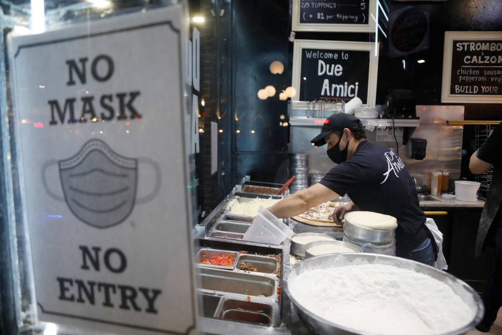 A pizza maker at Due Amici in Tampa’s Ybor City neighborhood at the start of Super Bowl LV festivities on Jan. 30, 2021.