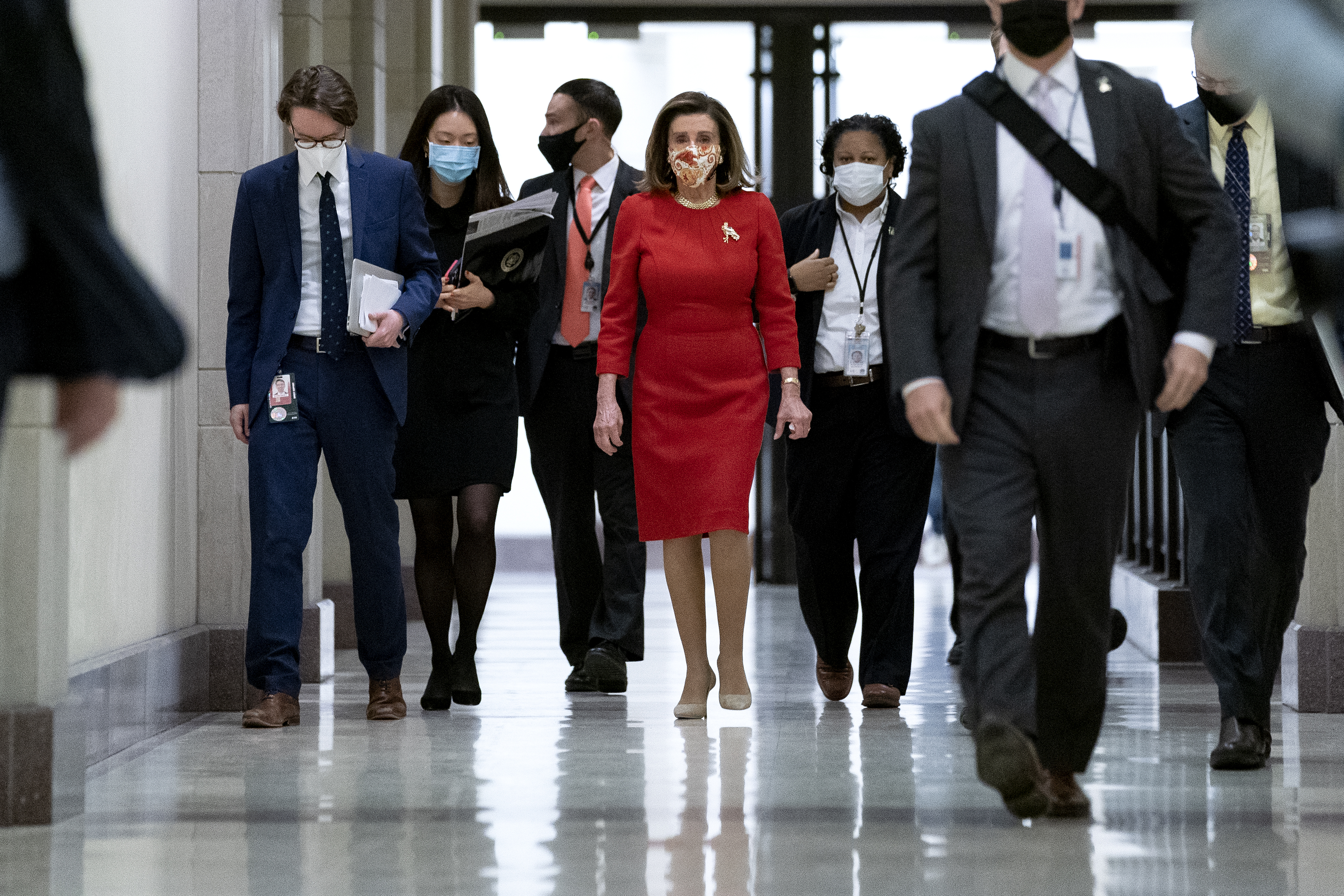 U.S. House Speaker Nancy Pelosi, a Democrat from California, center, wears a protective mask while exiting a news conference at the U.S. Capitol. Congressional committees have started crafting legislation on specific components of President Biden’s $1.9 trillion COVID-19 relief plan after votes in the House and Senate on a budget resolution setting up a legislative course to enact Biden’s stimulus without Republican votes.