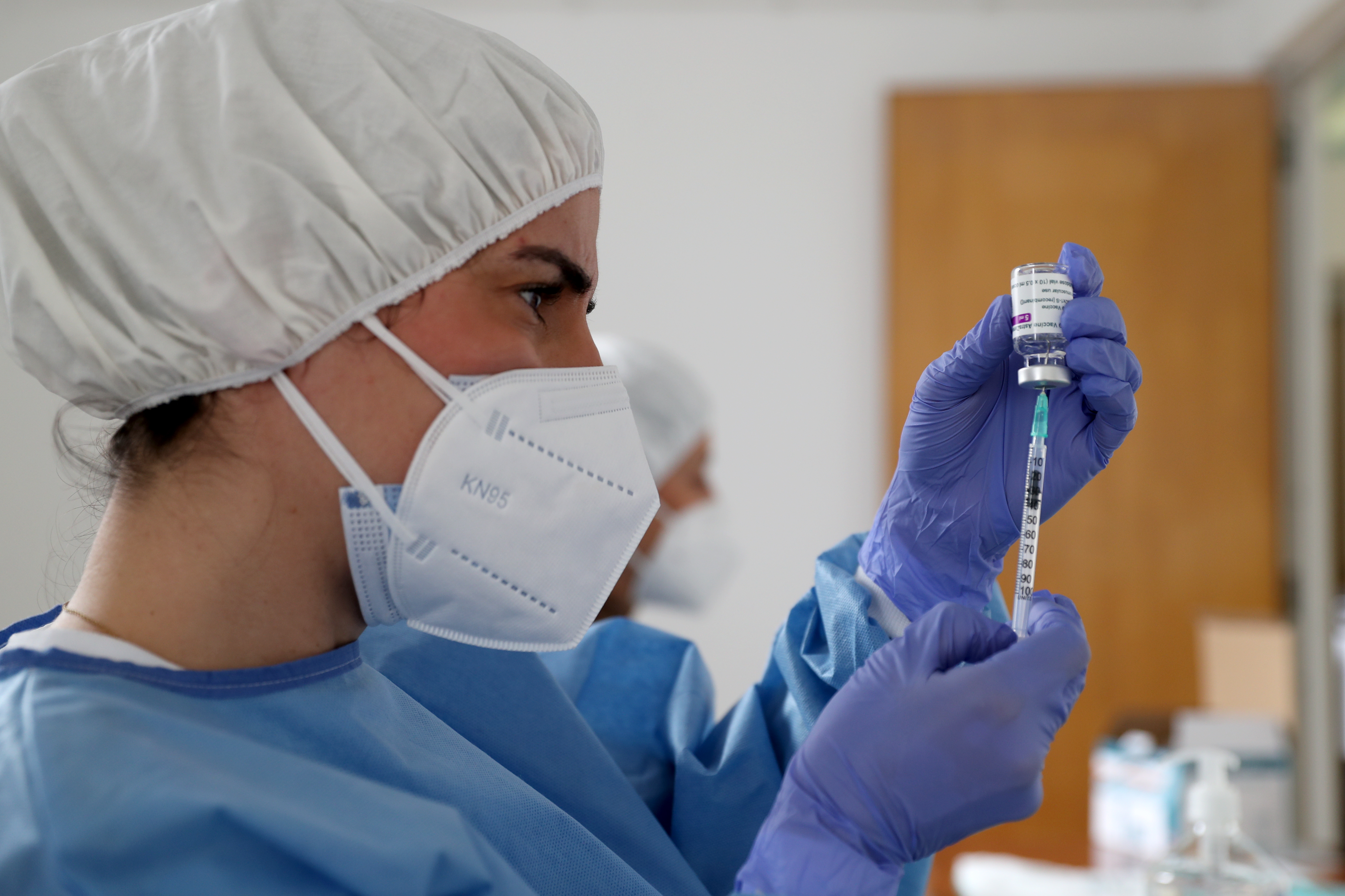 A health technician fills up a syringe with a dose of the AstraZeneca Covid-19 vaccine.