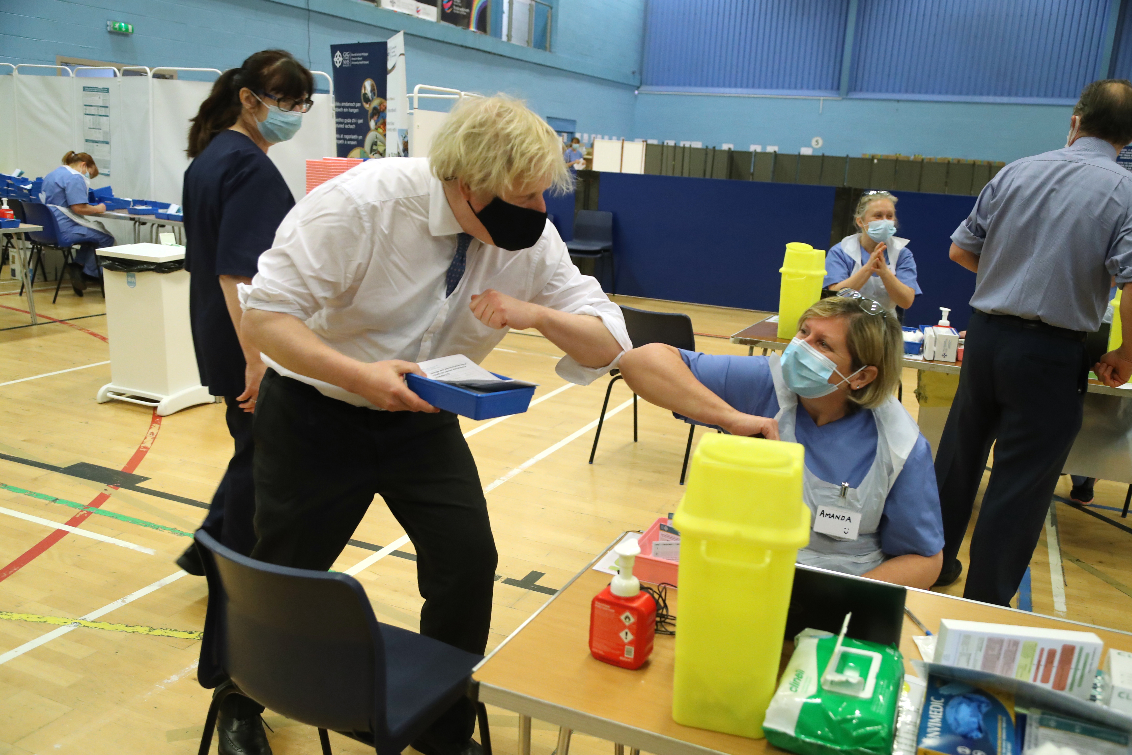 British Prime Minister Boris Johnson touches elbows with Senior Nurse Amanda Whent during a visit to the vaccination centre at Cwmbran Stadium on February 17, 2021 in Cwmbran, Wales earlier this month. Britain's success has driven the pound to be one of the best performing currencies of 2021. Wire photography: Geoff Caddick – WPA Pool/Getty Images