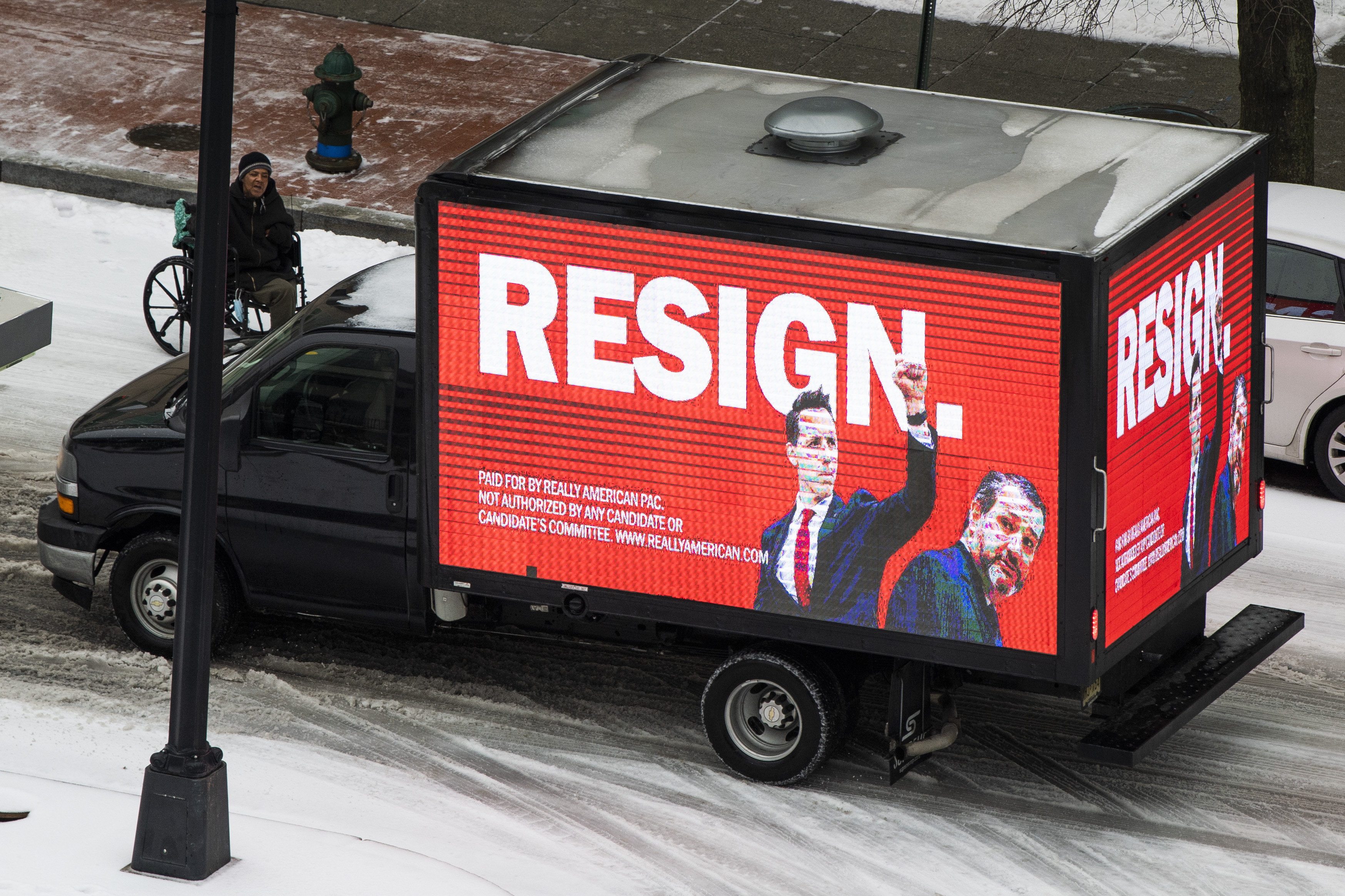 A truck with a sign paid for by Really American PAC to encourage Sens. Josh Hawley, R-Mo., and Ted Cruz, R-Texas, to resign, is seen on P Street NE, in the NoMa neighborhood as a winter storm moved though the Washington, D.C., area on February 18, 2021.