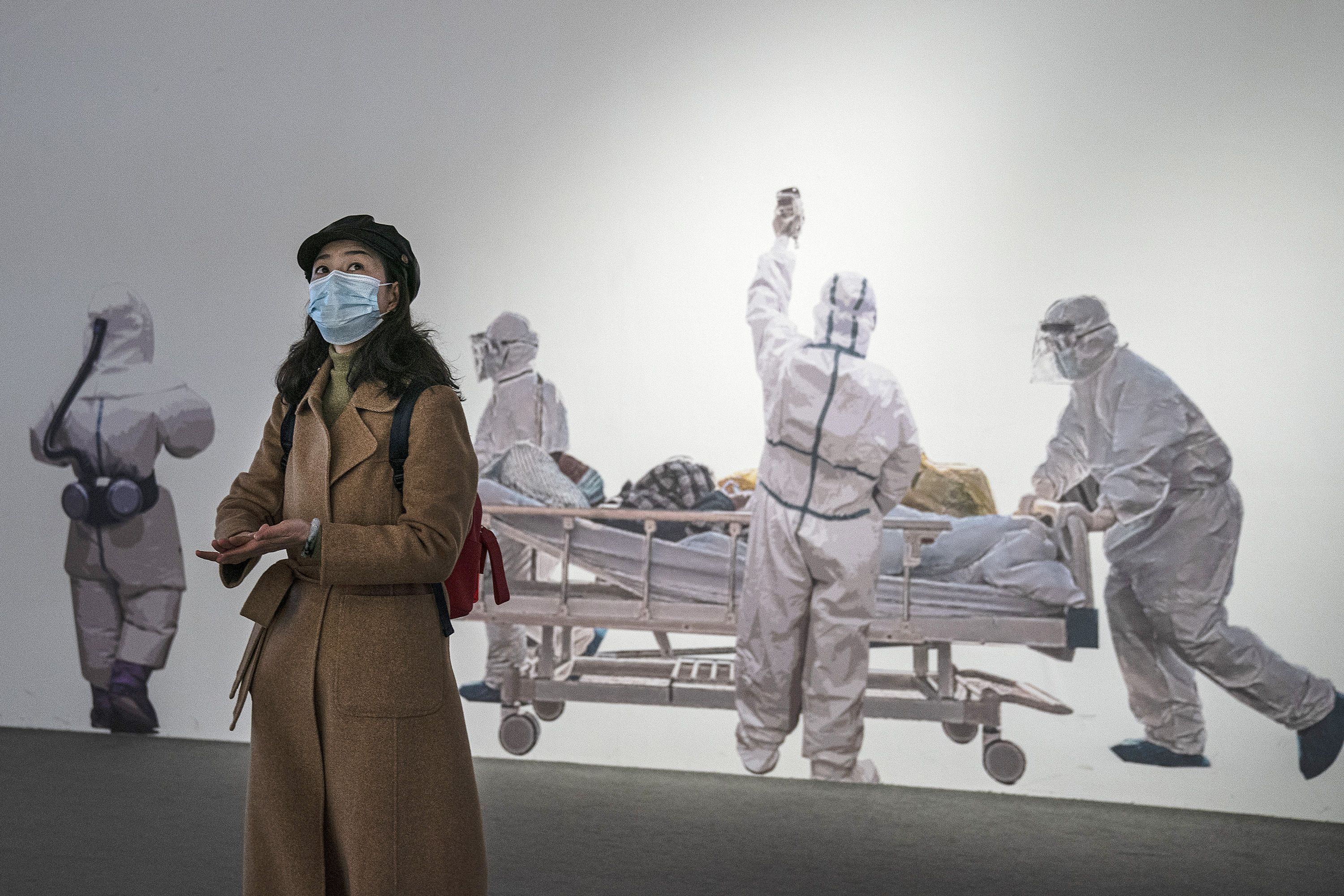 A woman wears a face mask as she visits an exhibition on the city's fight against the coronavirus in Wuhan, China. The WHO team has been in Wuhan carrying out investigations into the origins of the coronavirus.