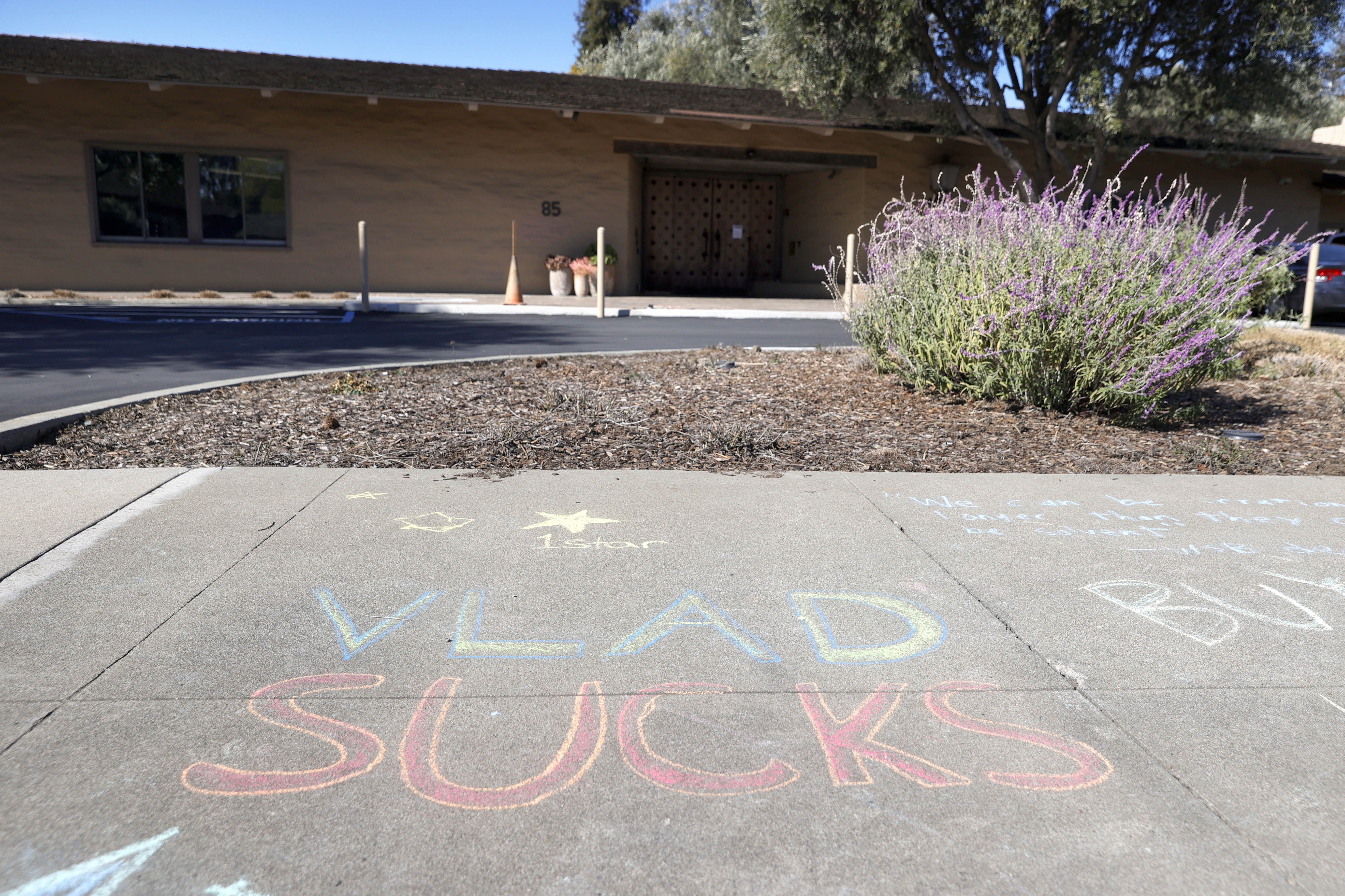 A chalk drawing referencing Vladimir Tenev, the co-founder of trading app Robinhood, is visible on the sidewalk in front of the company's headquarters in Menlo Park, California. Tenev is scheduled to testify in a historic House hearing on Thursday. 