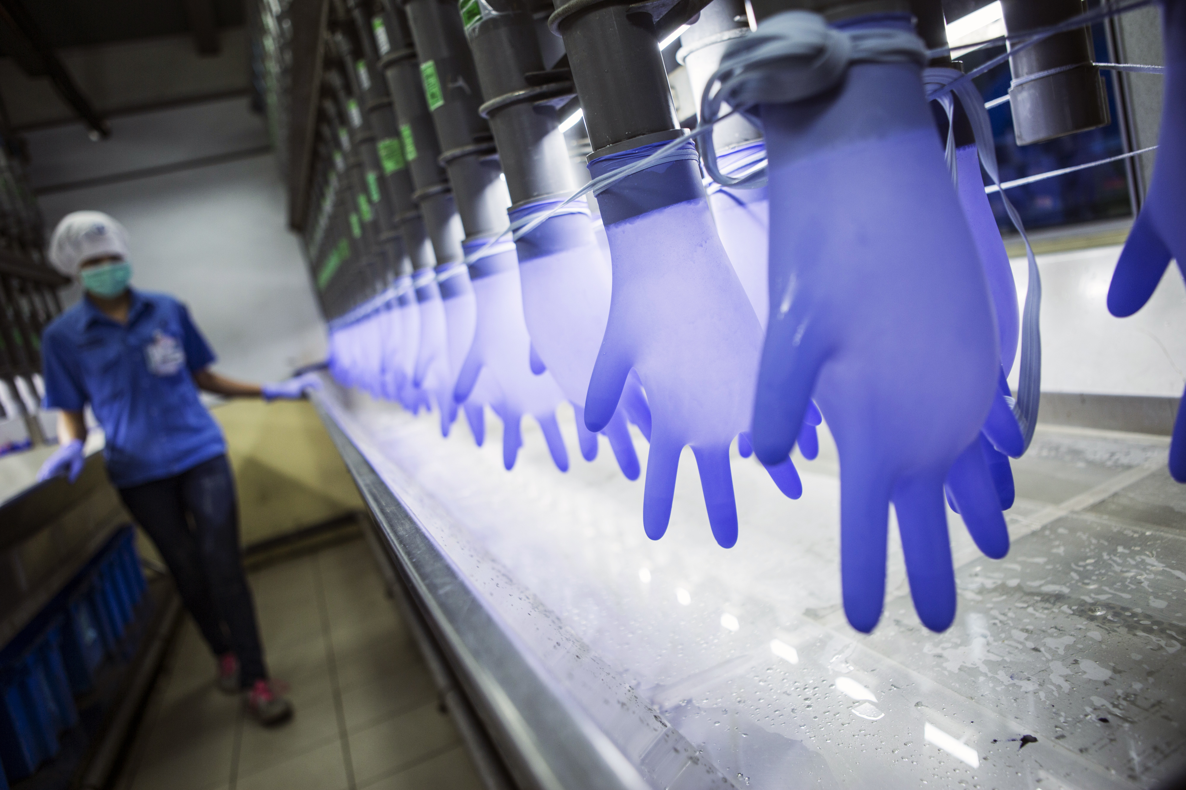 Latex gloves are filled with water in a watertight test room at a Top Glove Corp. factory in Setia Alam, Selangor, Malaysia, on Thursday, Dec. 3, 2015. Top Glove, the world's biggest rubber-glove maker, raised its owners fortunes during the pandemic.
