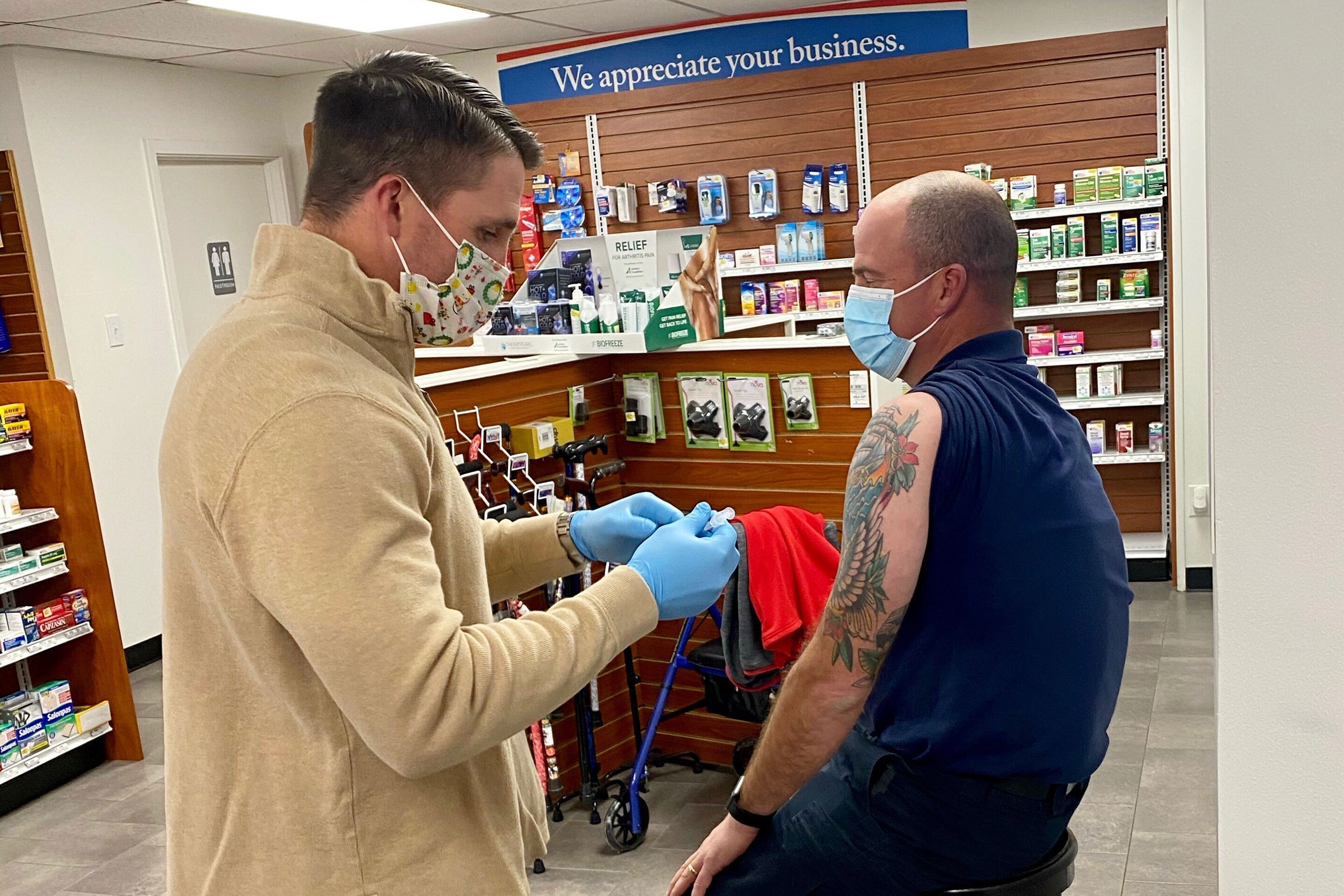 Adam Bayer of Hillcrest Pharmacy in Vernon, Texas, administers a coronavirus vaccination. Hillcrest's first batch of doses arrived this week as part of a new Federal program to distribute the vaccine to pharmacies.