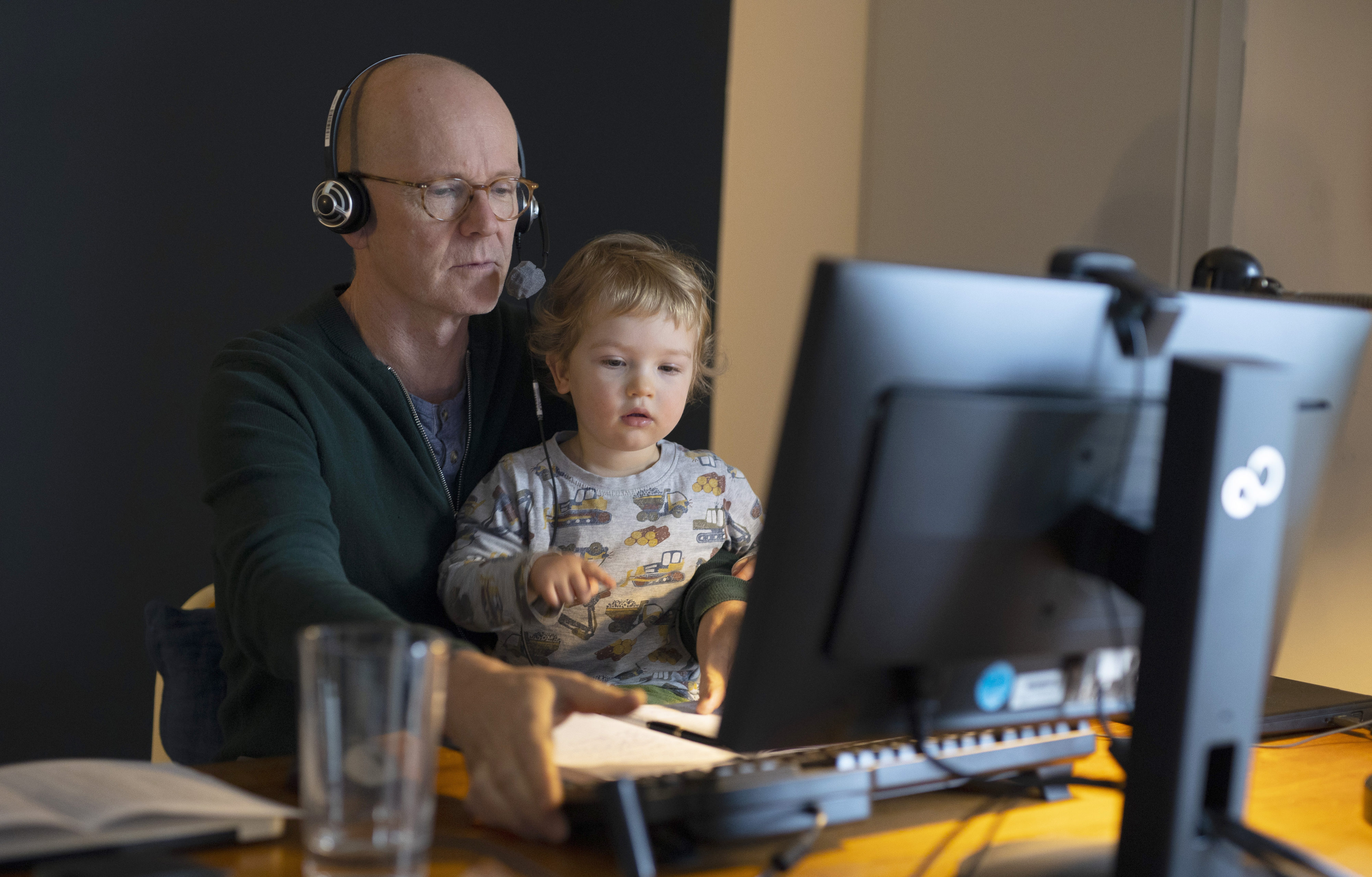 In this photo illustration a man with toddler at desk doing homeoffice on January 14, 2021 in Bonn, Germany.