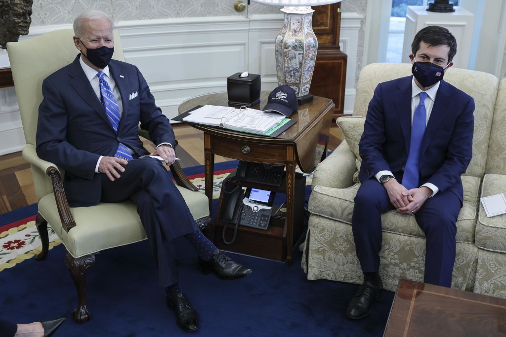 U.S. President Joe Biden and Pete Buttigieg, U.S. secretary of transportation, wear protective masks during a meeting on infrastructure with House members in the Oval Office of the White House in Washington, D.C., U.S., on Thursday, March 4, 2021. U.S. infrastructure including roads, bridges and sewers received a mediocre grade from the American Society of Civil Engineers, an assessment that will help buttress Biden's coming plan for a major infrastructure-spending package.