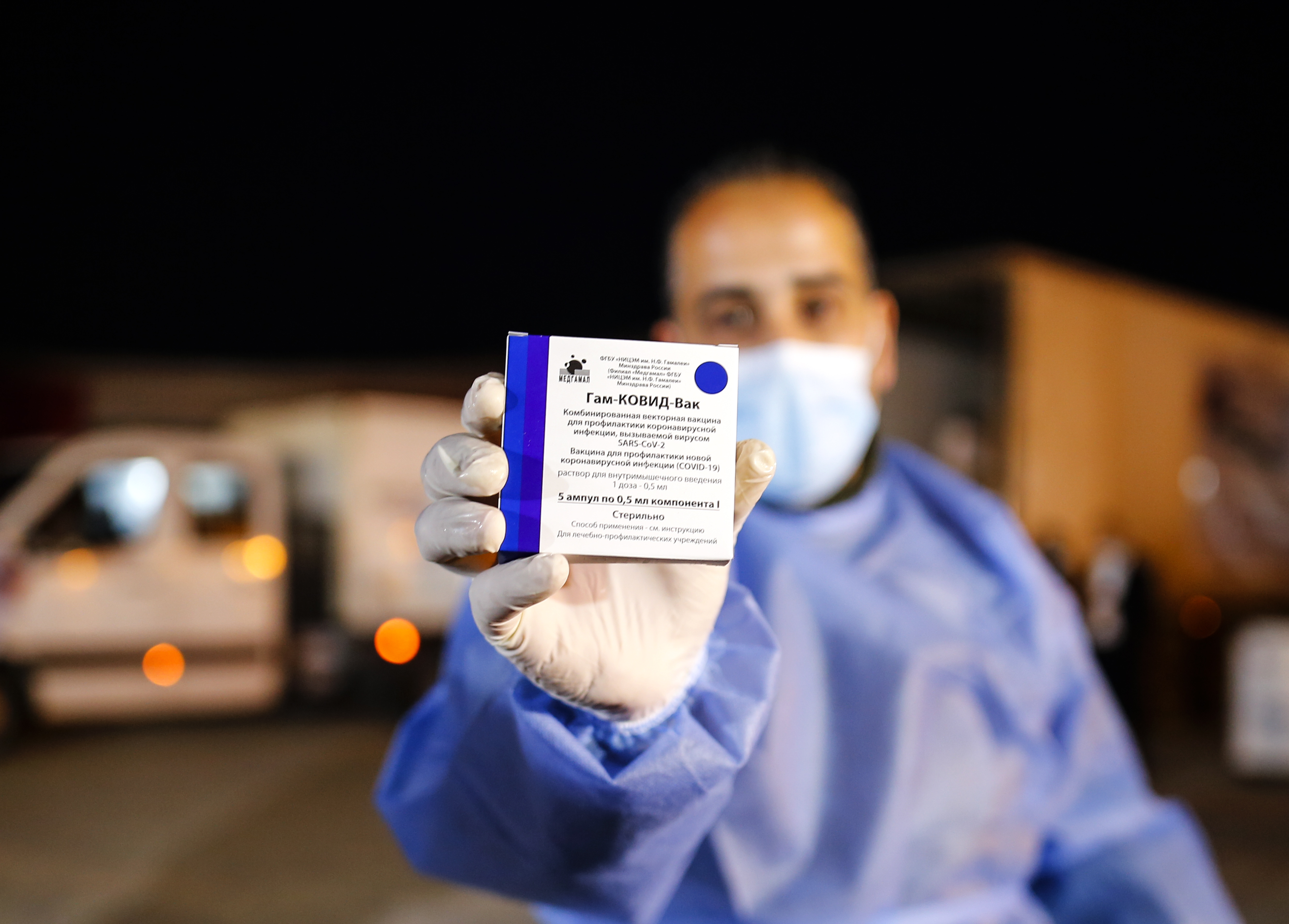 A Palestinian medic holds up a box of the Russian Sputnik V coronavirus vaccines at the Rafah Border Crossing, Gaza Strip. Every new market is heralded as a promotional opportunity for the hyperactive Sputnik V social media team.