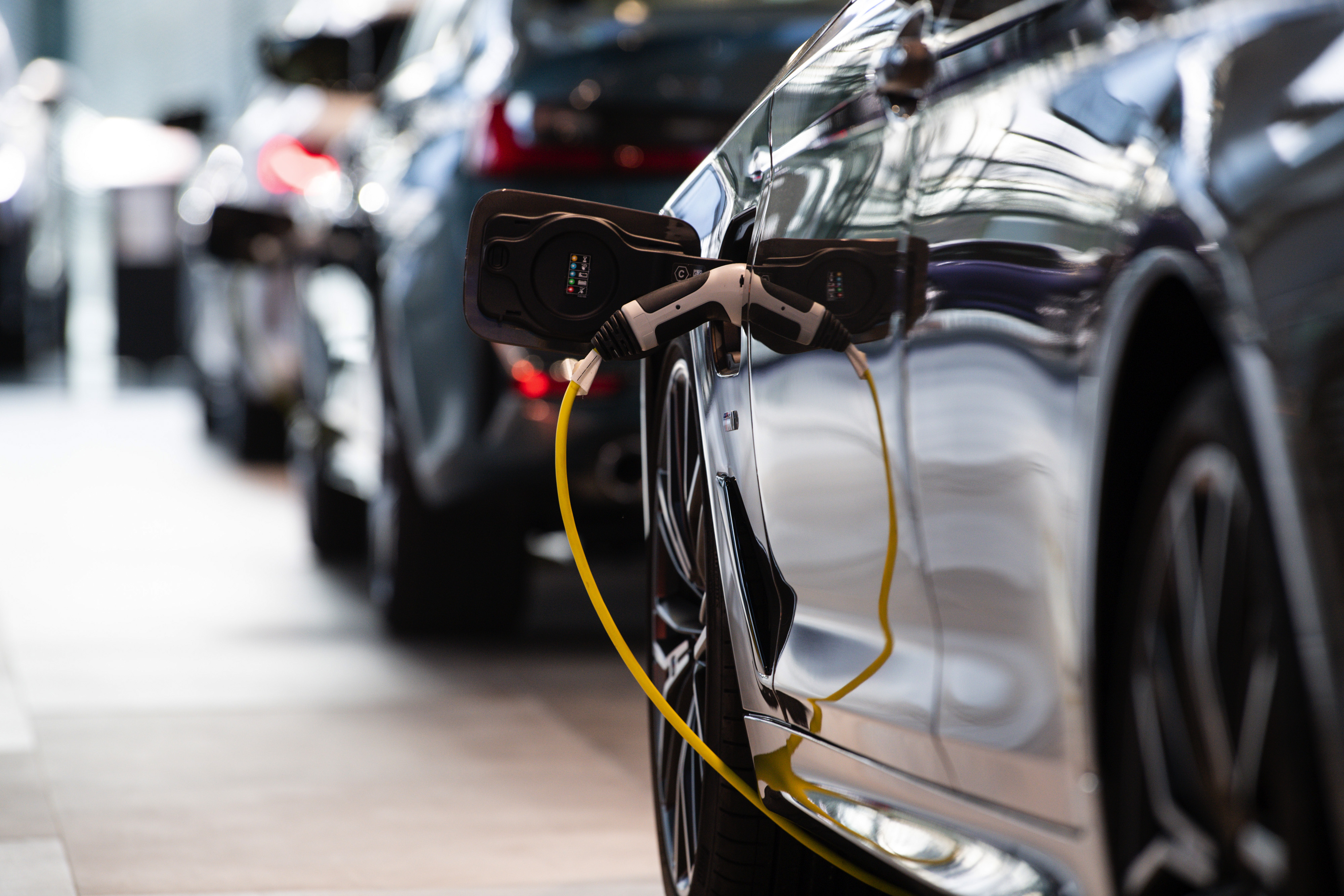 An electric charging cable connected to a BMW 5 Series luxury electric automobile at the BMW Welt automobile showroom, operated by Bayerische Motoren Werke AG, in Munich, Germany, on Friday, March 12, 2021. BMW expects profit to rise this year, building on positive momentum from late last year when sales recovered in key regions. 