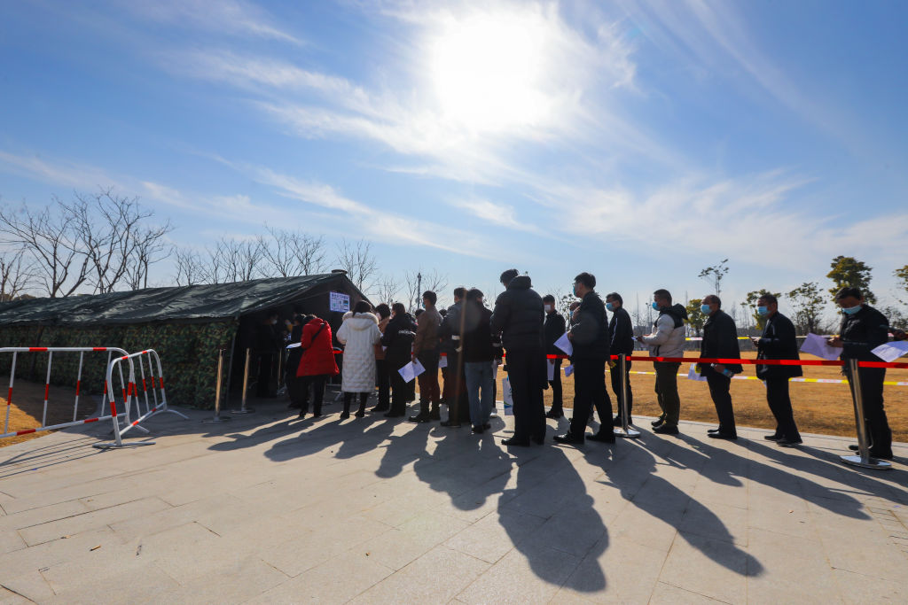 Residents line up to receive the COVID-19 vaccine at a clinic in Shanghai on Jan. 14, 2021.