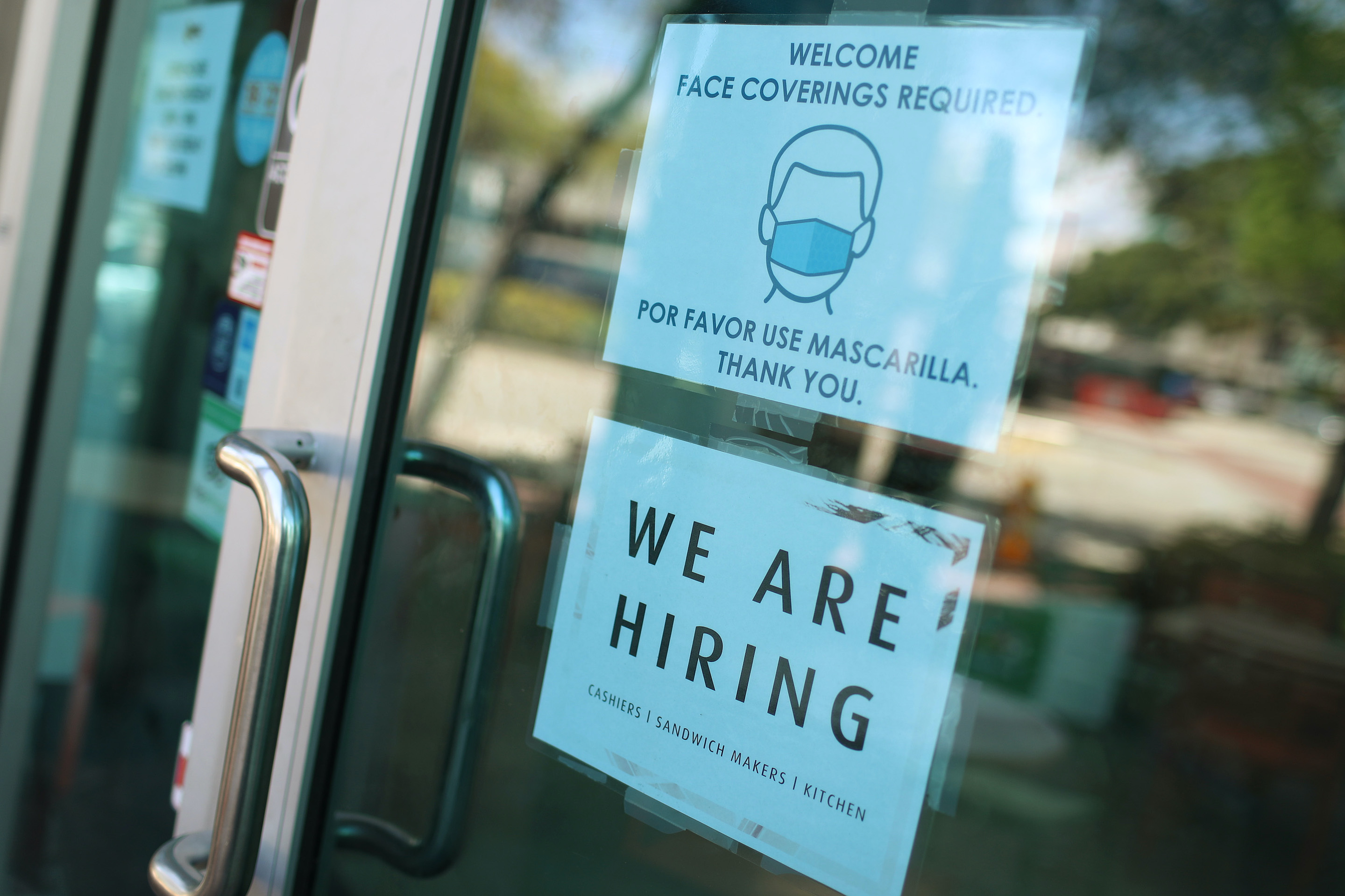 A "We Are Hiring" sign on a storefront in Miami, Fla., on March 5, 2021.